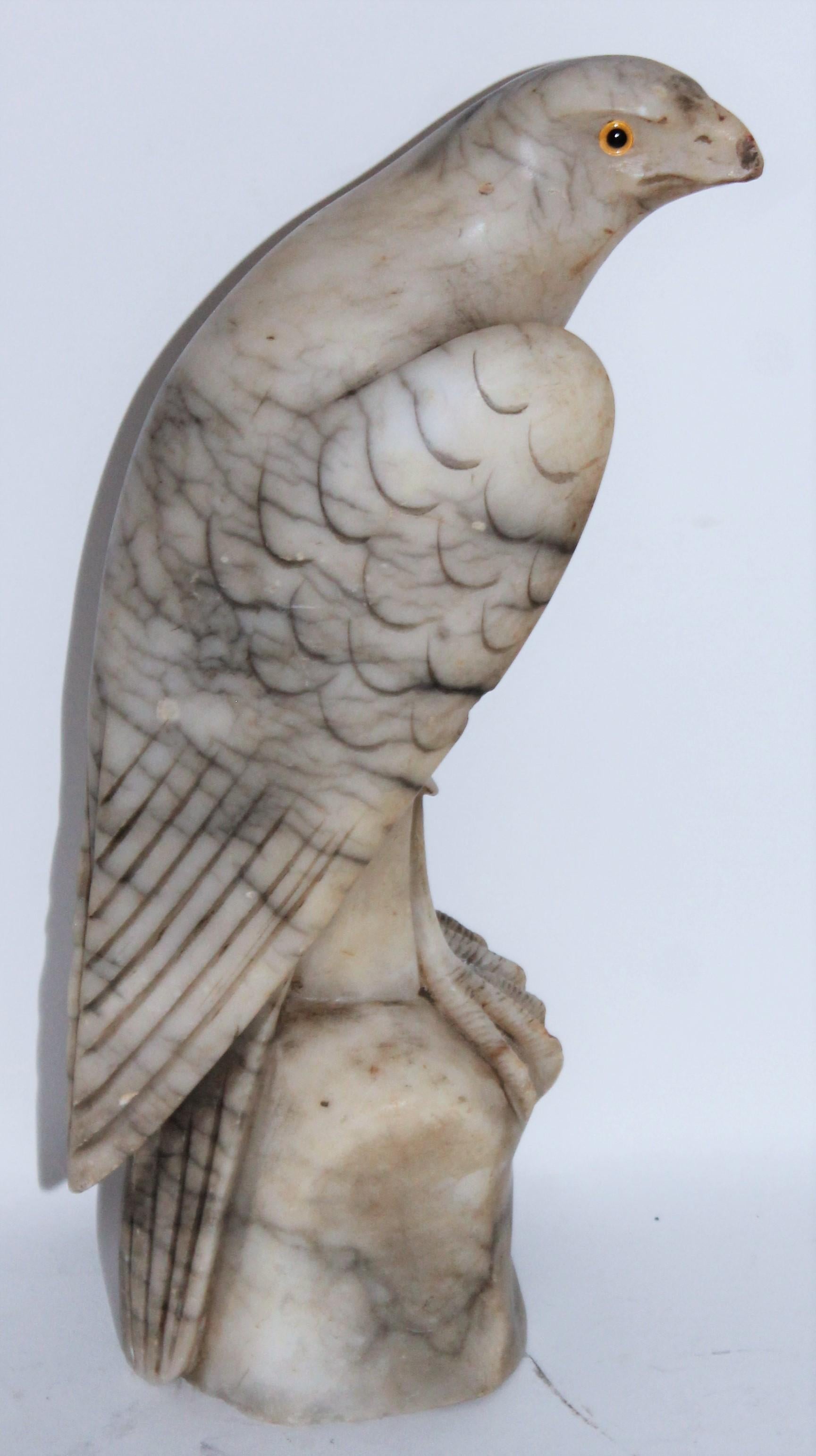 This fine hand carved alabaster hawk has the original glass eyes and in amazing condition. The body has amazing carving details. This sculpture is very fine and well carved.
