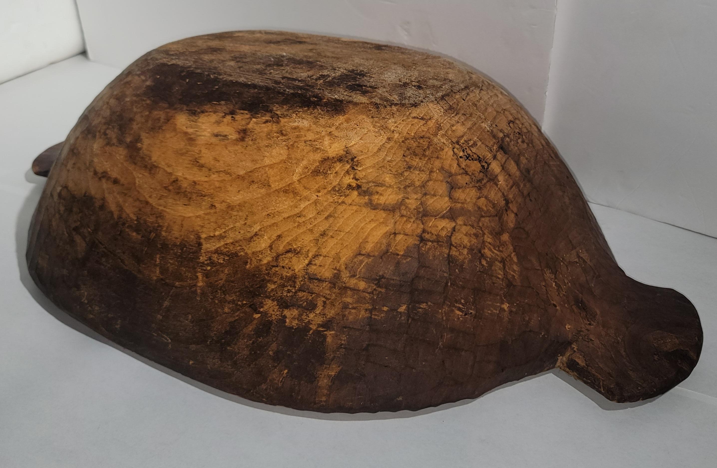 This hand carved bowl was found in Canada and is in good condition with hand carved handles.Nice aged patina and no cracks.