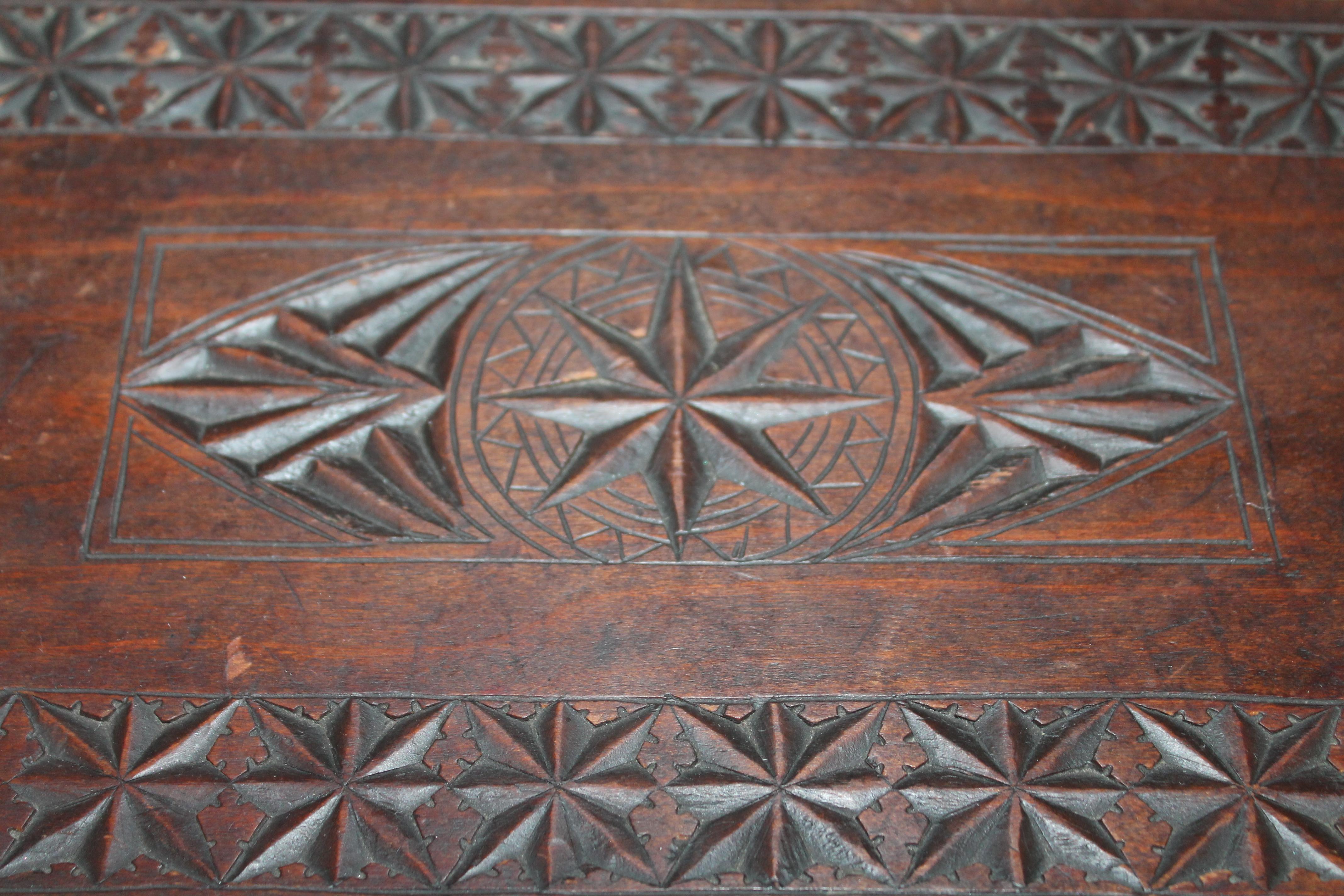 19th century hand carved nautical foot stool with cutout hearts on the sides. Detailed carving through out.