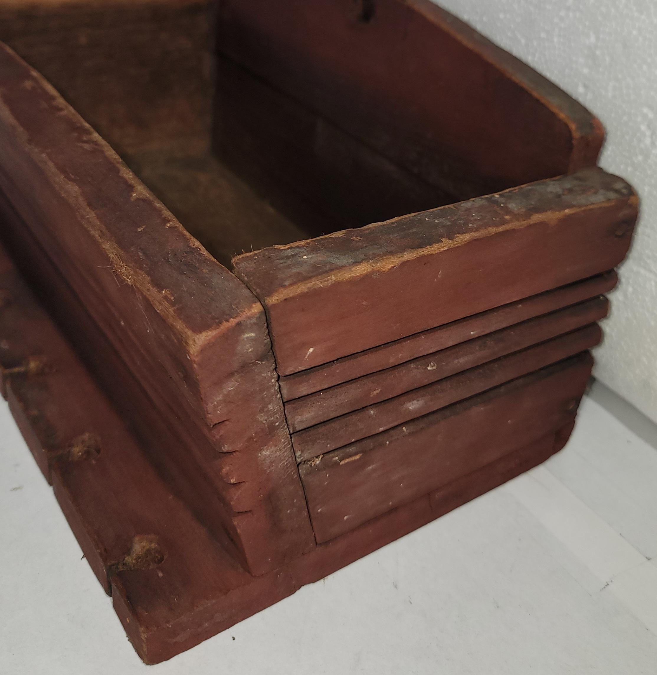 Cette boîte murale originale du 19e siècle, peinte en rouge, a des découpes pour les cuillères sur le devant et est en très bon état.  Trouvé dans l'état du Maine.