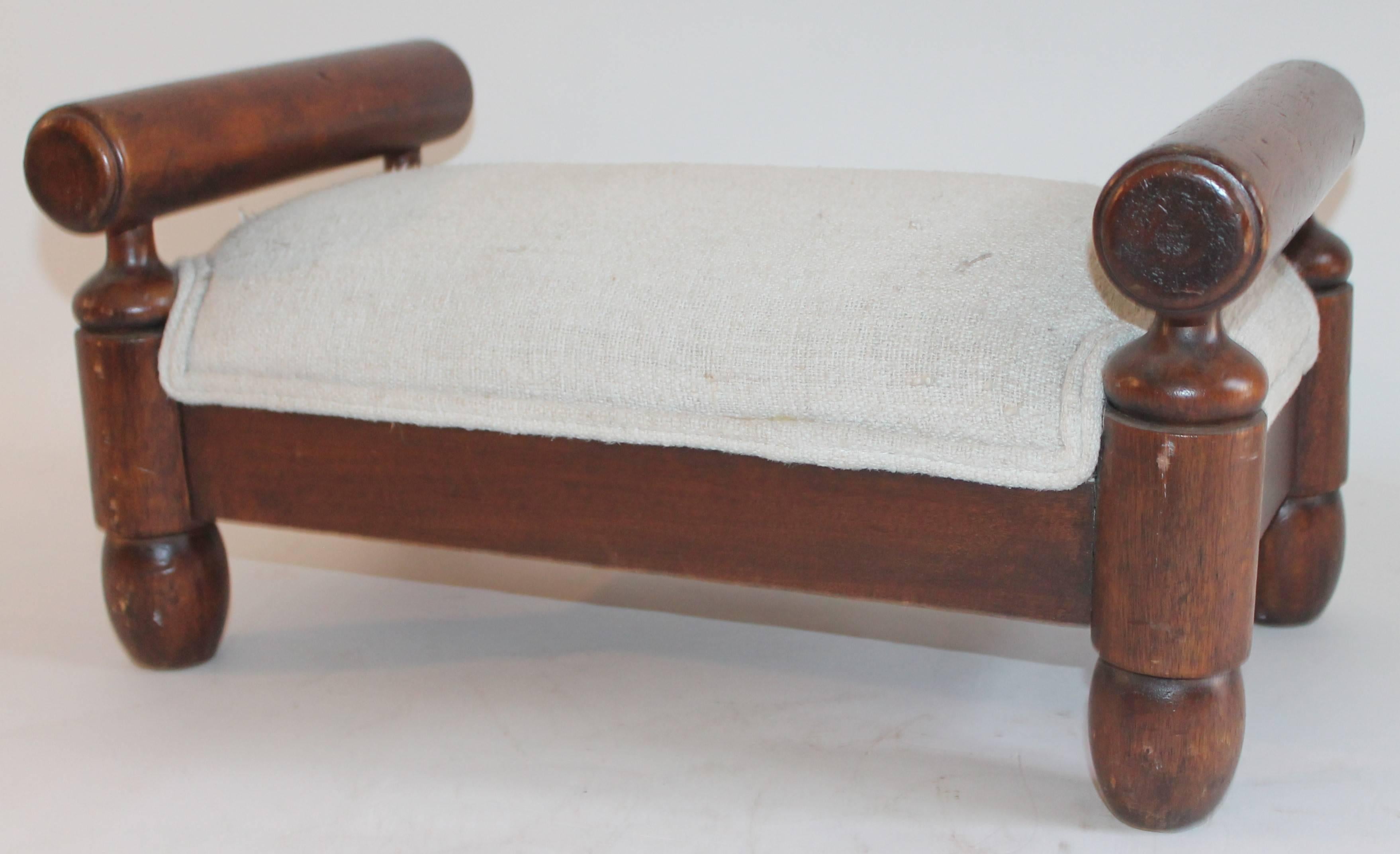 19th century handmade foot stool with homespun linen upholstery. This stool is in pristine condition.