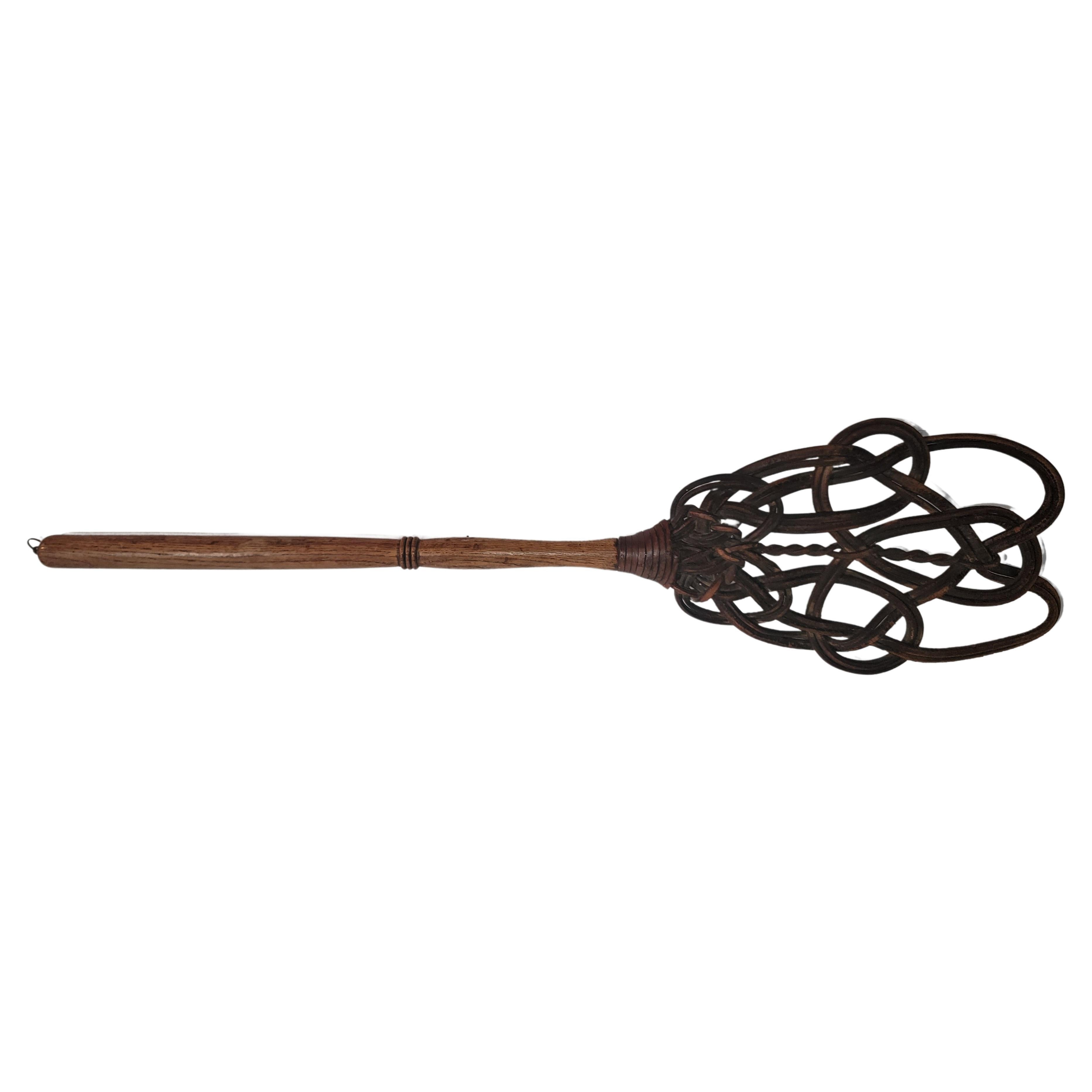19th century hand made and hand woven braided leather rug beater.Hand carved hickory wooden handle. Amazing patina and very strong.