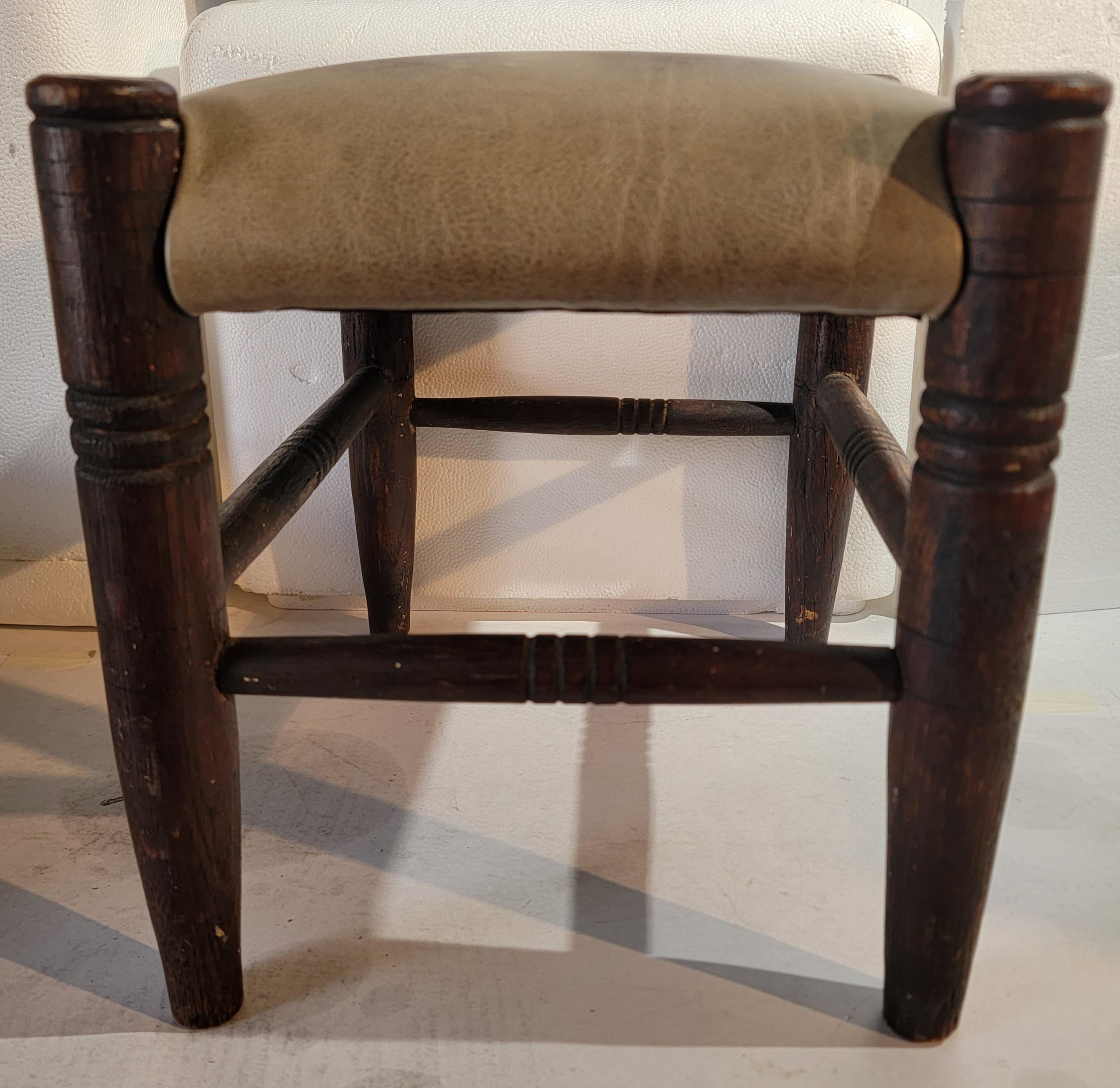 This early 19thc turned leg early stool is in sturdy condition.The top is in a newly upholstered leather.