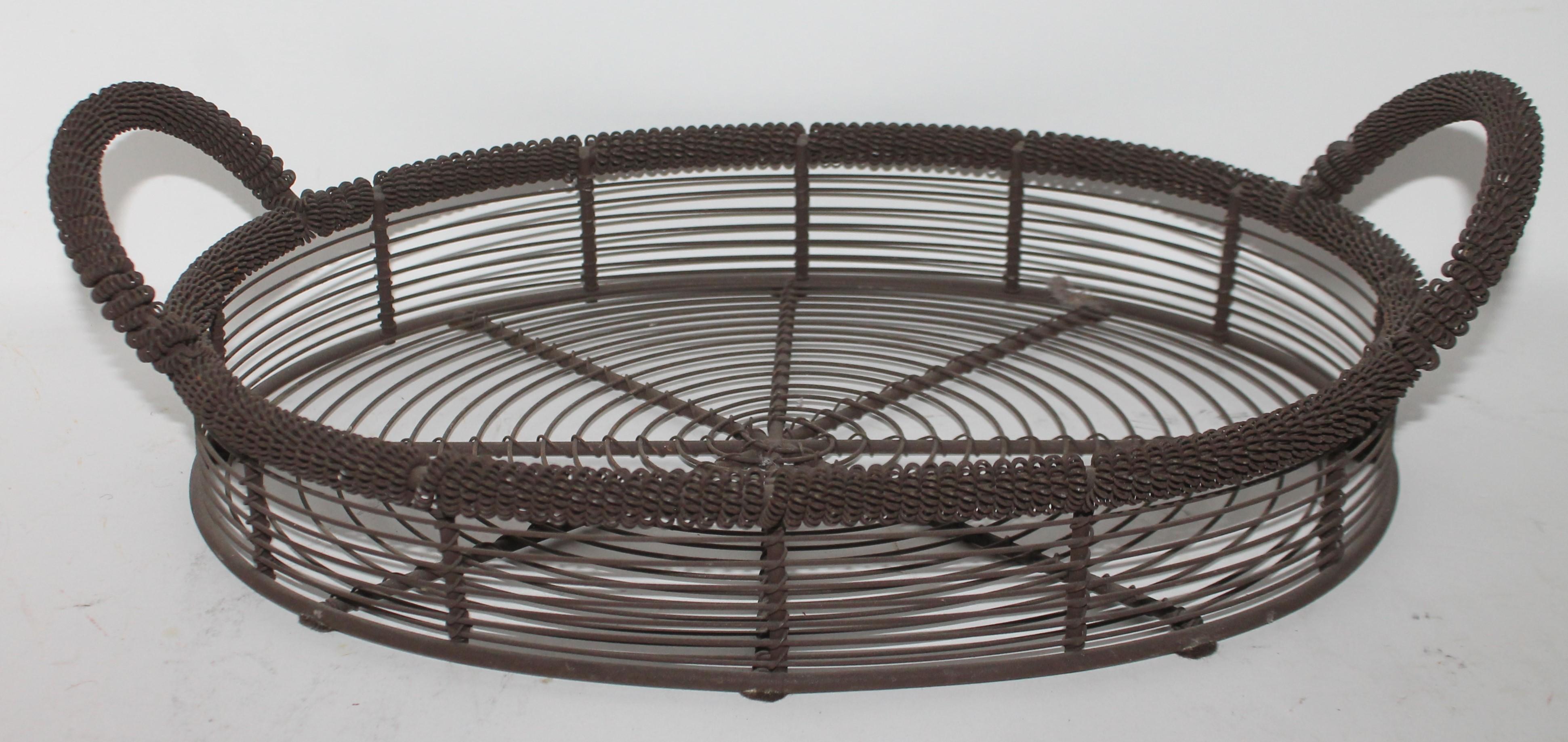 This 19th century handmade wired double handled basket is in fine condition and is very heavy and sturdy.