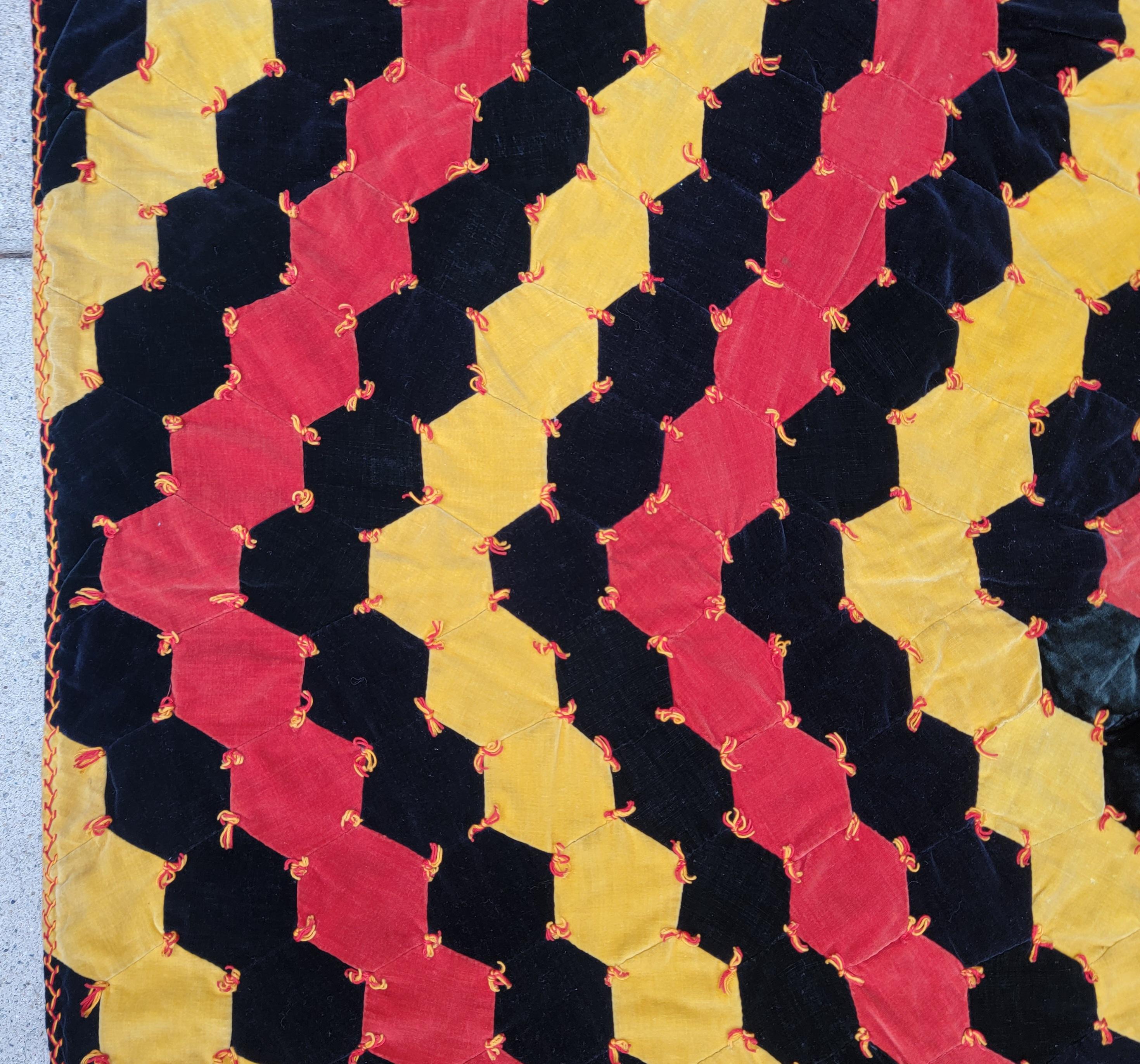 This amazing hand pieced and tied all velvet hexagon quilt is in pristine condition. This has such a geometric look.