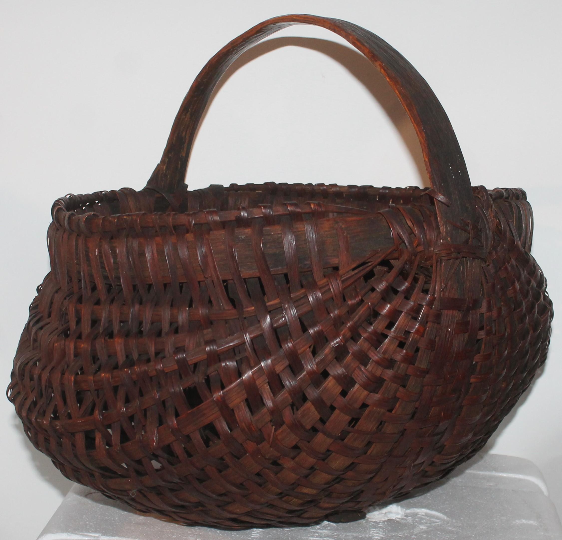 19th century handwoven hiney basket from Pennsylvania in good condition with several minor breaks.