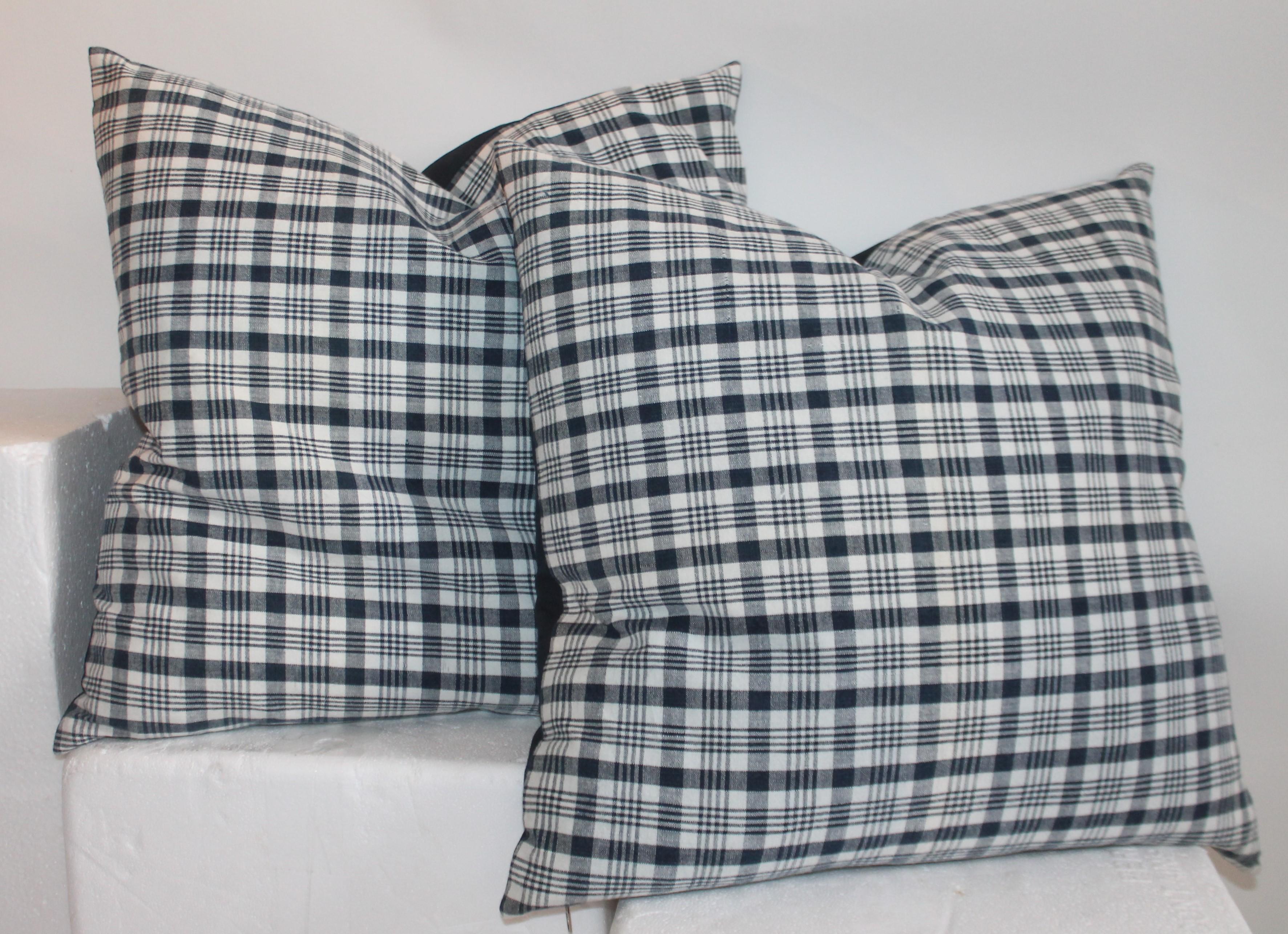 Pair of large pillows measure 22 x 22 19th century linen homespun indigo and white linen pillows. The backings are white cotton linen. The inserts are down and feather fill.
Smaller pillows measure 20 x 20.
 