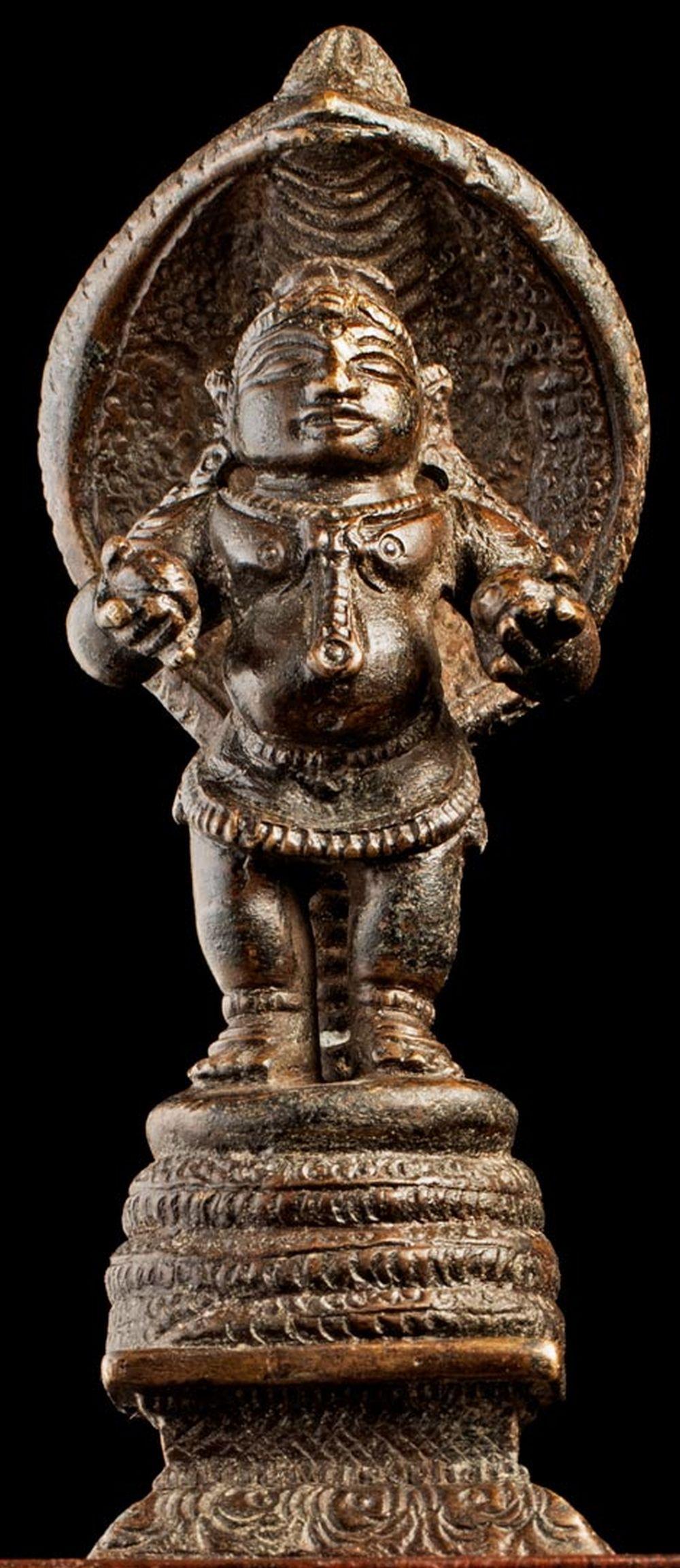 Good 19th C Indian bronze figure. Measures 4 1/2 inches tall x 1 3/4 inches at its widest point x 1 3/4 inches at its deepest point.