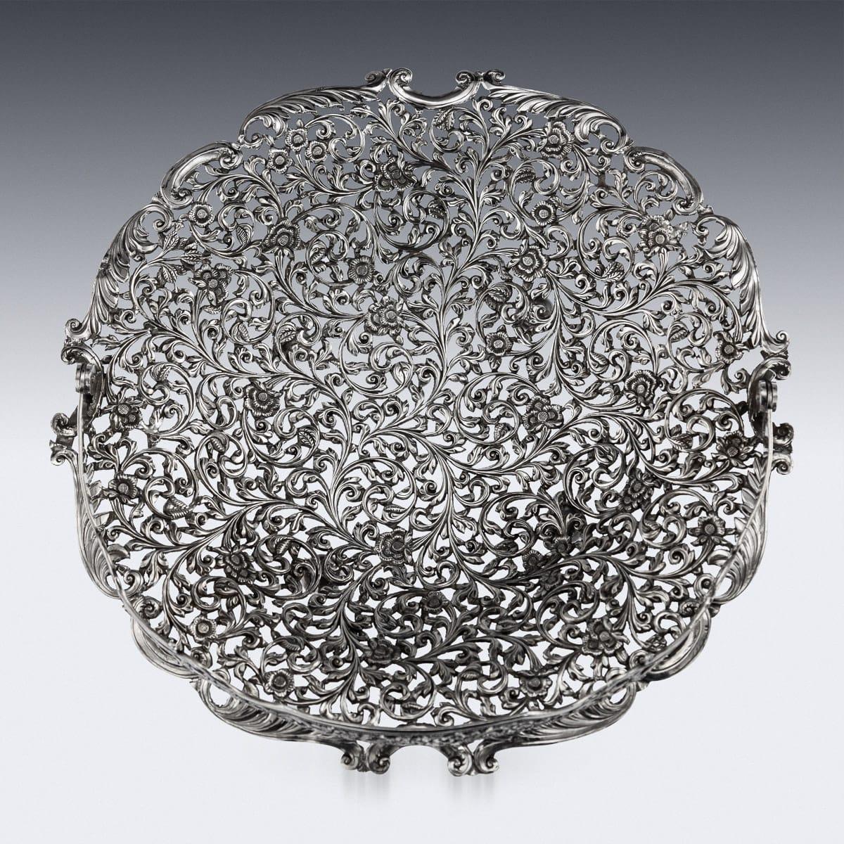 Antique 19th century Indian Kutch (Cutch), Bhuj, Gujarat region hand crafted and pierced solid silver basket, of shaped round form on four ball feet, finely chased and pierced with scrolling leaves and flower pattern in a finely tooled background,