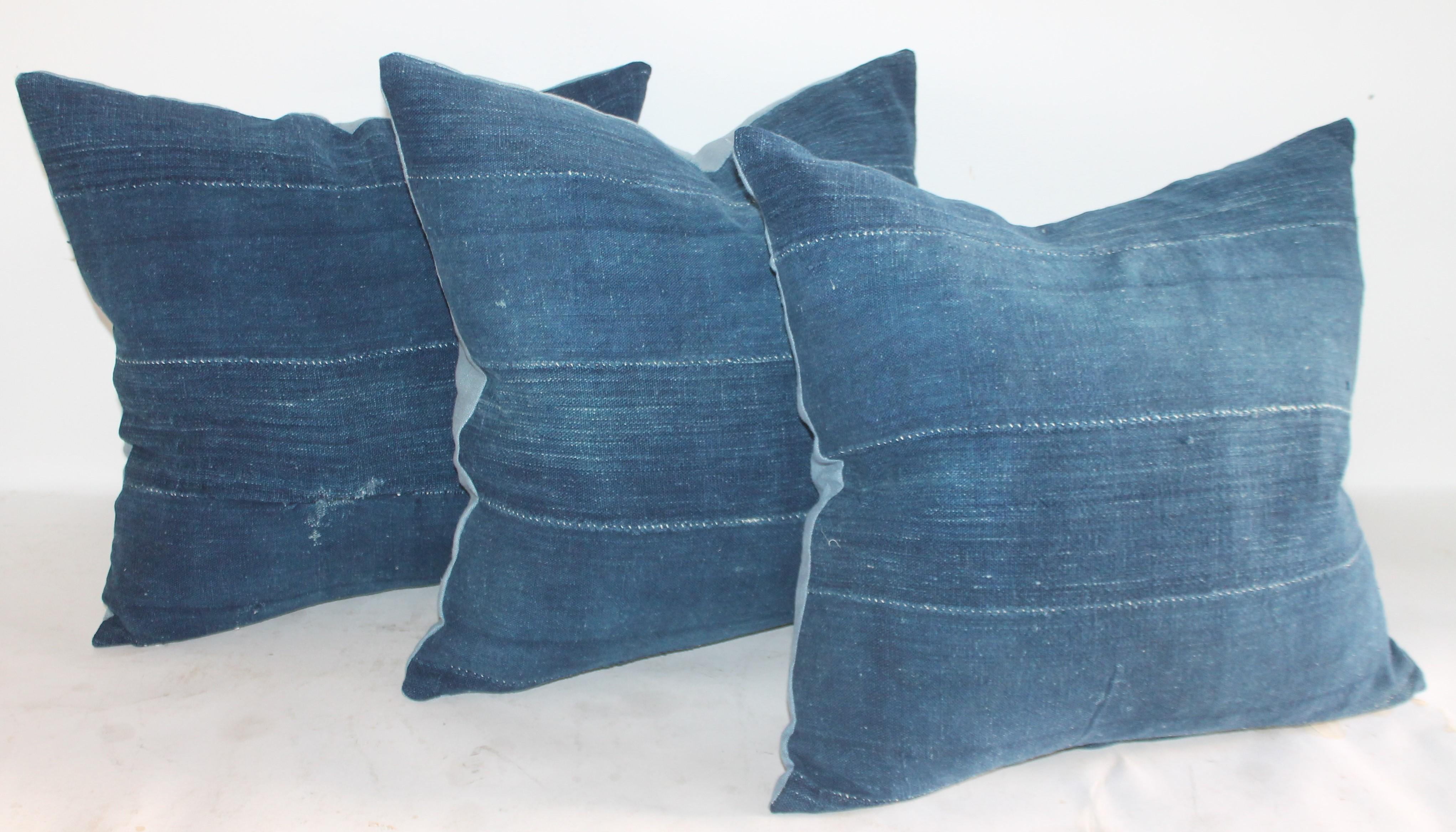 Collection of three indigo blue linen pillows with light blue linen backings. The inserts are down and feather fill.
