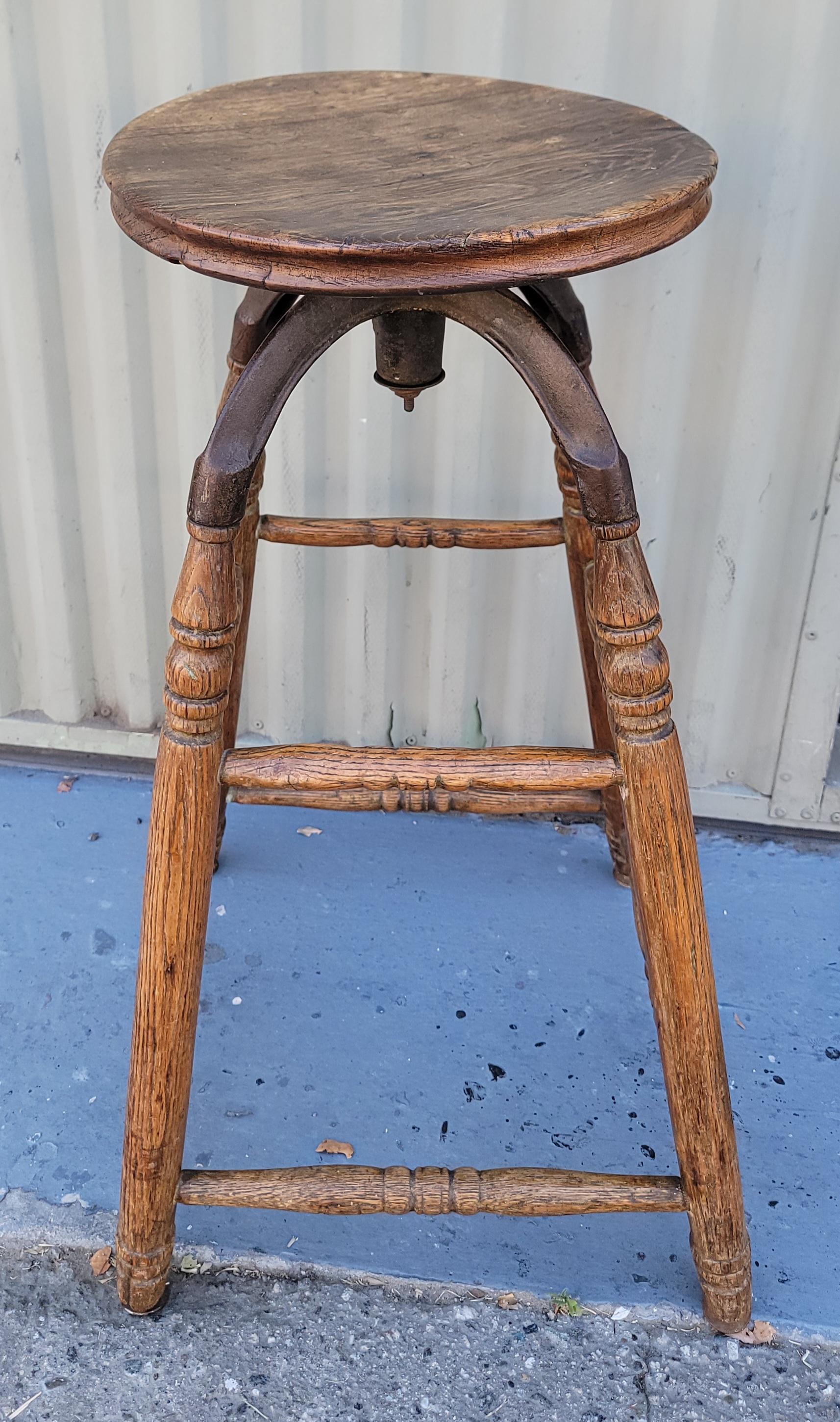 19Thc Industrial swivel bar stool with iron and wood.The stool has a fine patina and wonderful folky form.