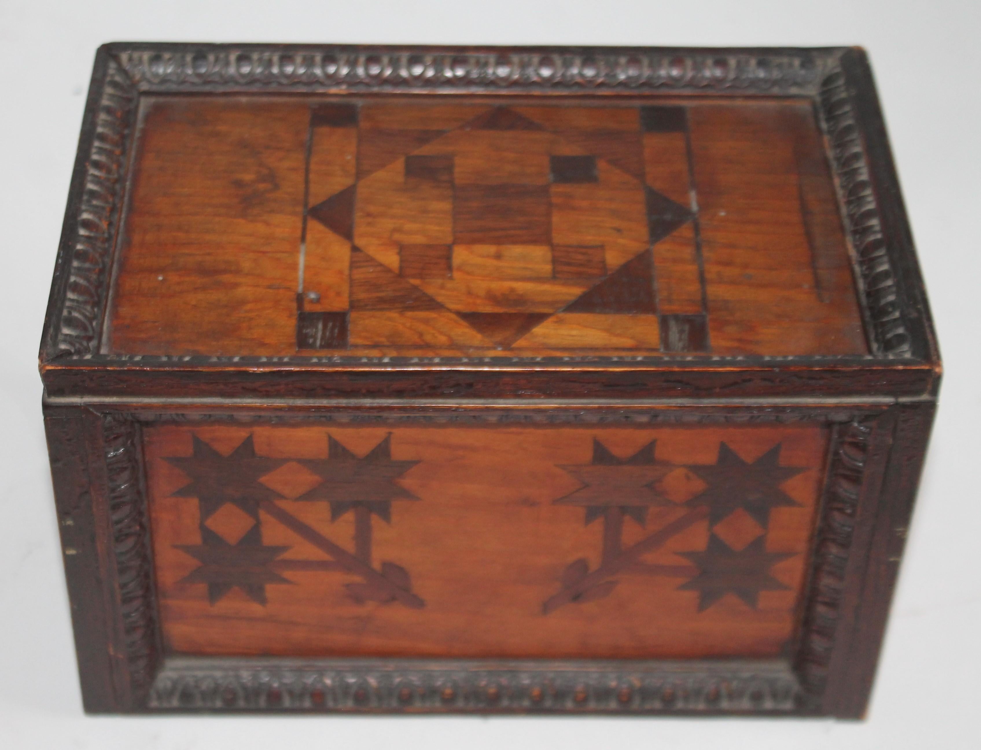 This original surface slide top inlaid box for gaming pieces (checkers). This box has a game board inlaid on the slide top and a folky flowers throughout the box .On all four sides. Great addition to a Folk Art or game board collection.