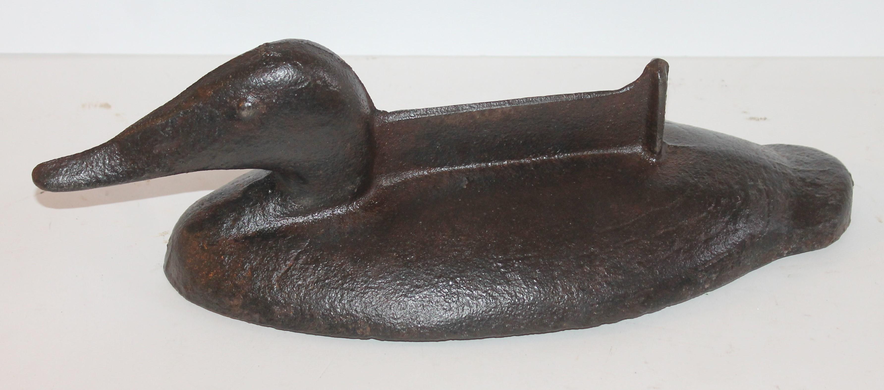 This amazing cast iron and super heavy duck door stop and combo boot scraper is in good condition. The eyes are painted black and it has a nice worn patina. This is probably a Hubley door stop.