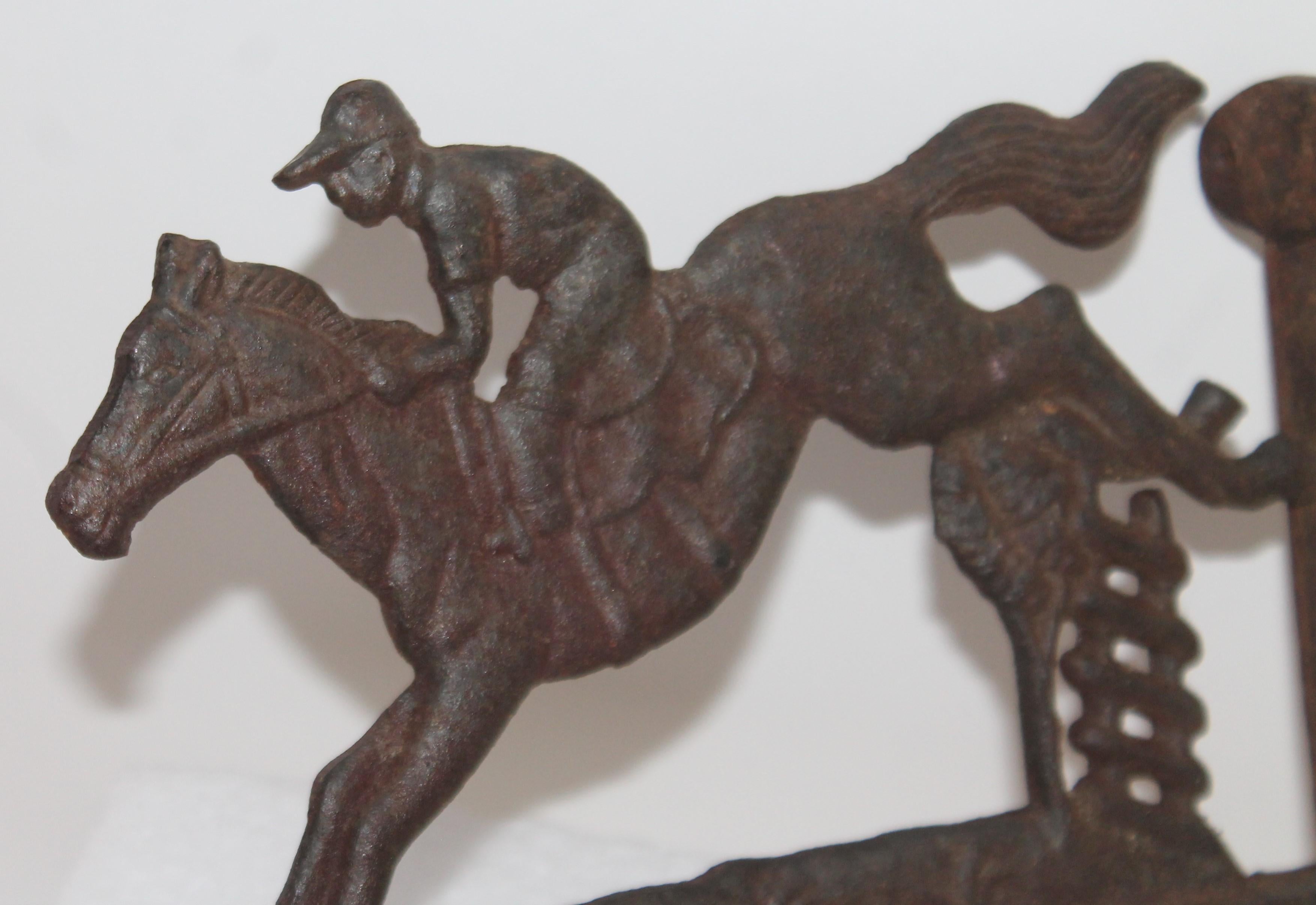 This folky wall mount of a horse and rider is in fine as found condition with a nice aged patina. This could be used as a basket holder or iron pit holder near a fire place.