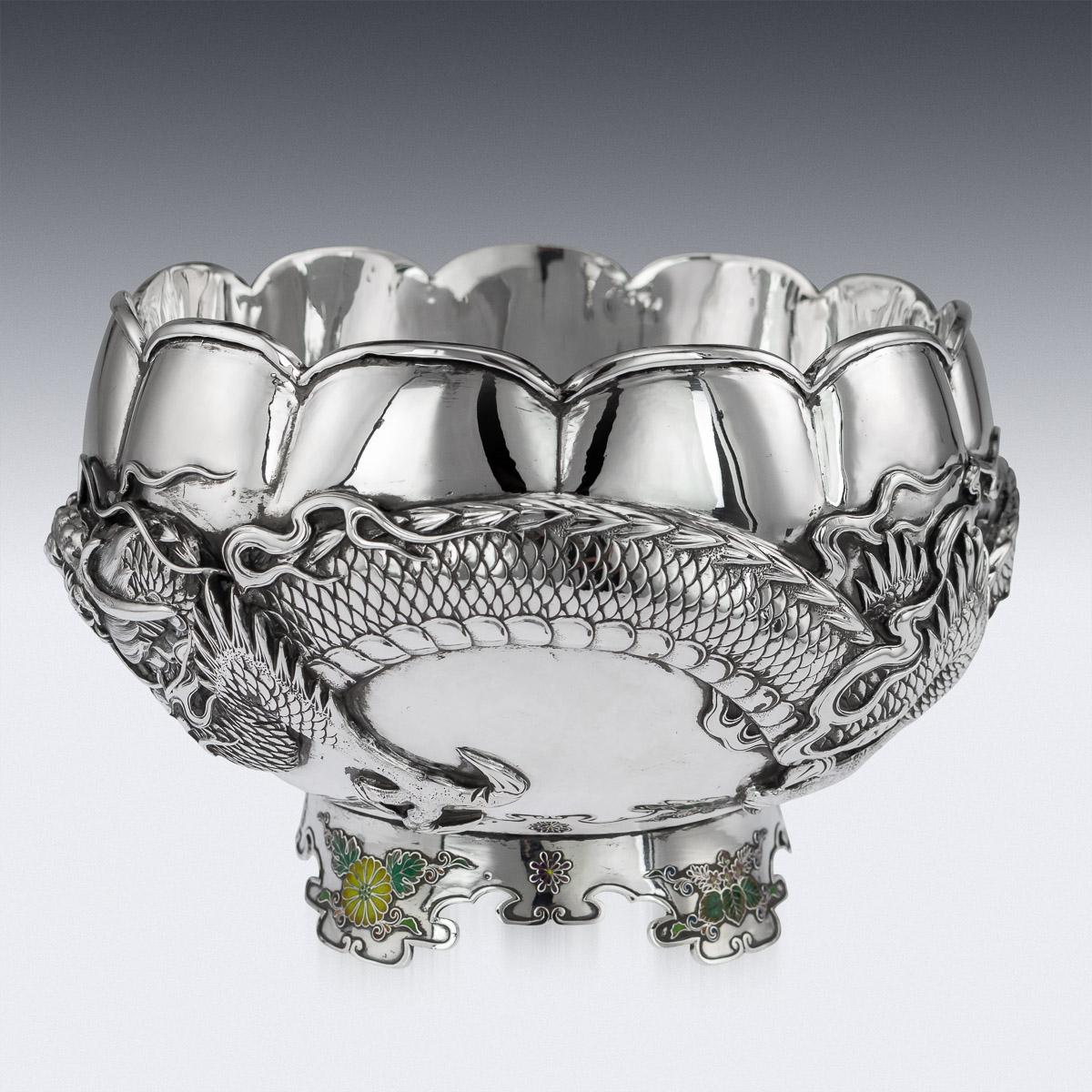 Antique late-19th century Japanese, Meiji period solid silver & enamel dragon bowl, exceptional and magnificent quality, double walled, chased, embossed and applied with a water dragon in very high relief, with flowing whiskers. The shaped foot