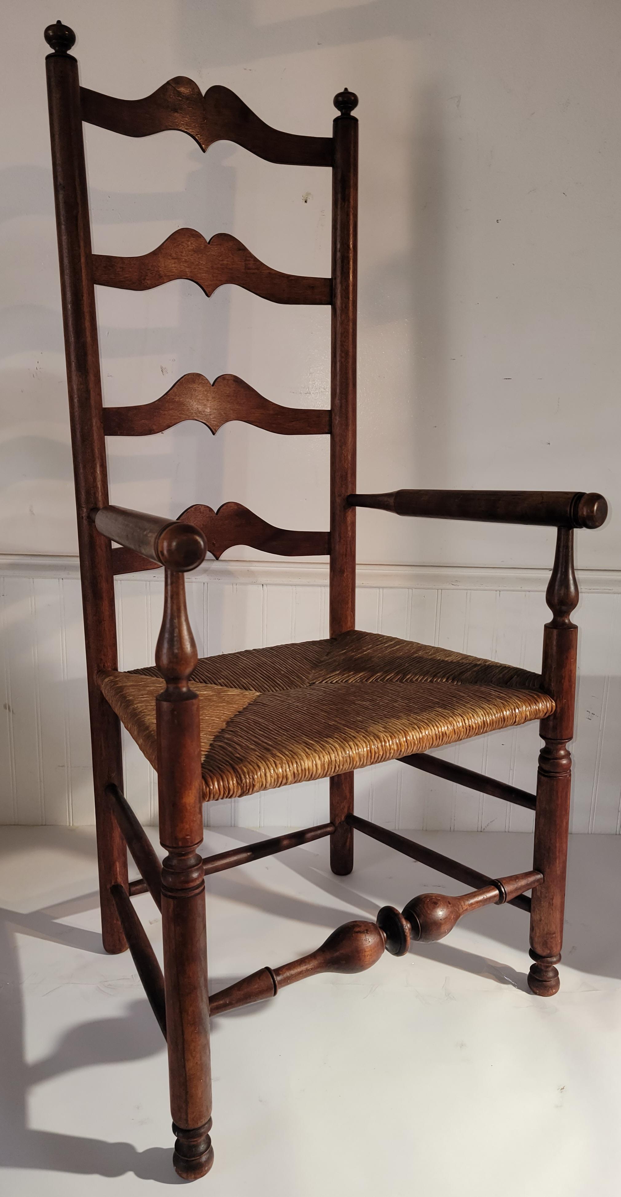 19Thc New England ladder back arm chair with hand woven seat.This chair has most unusual cut outs and wonderful aged patina.