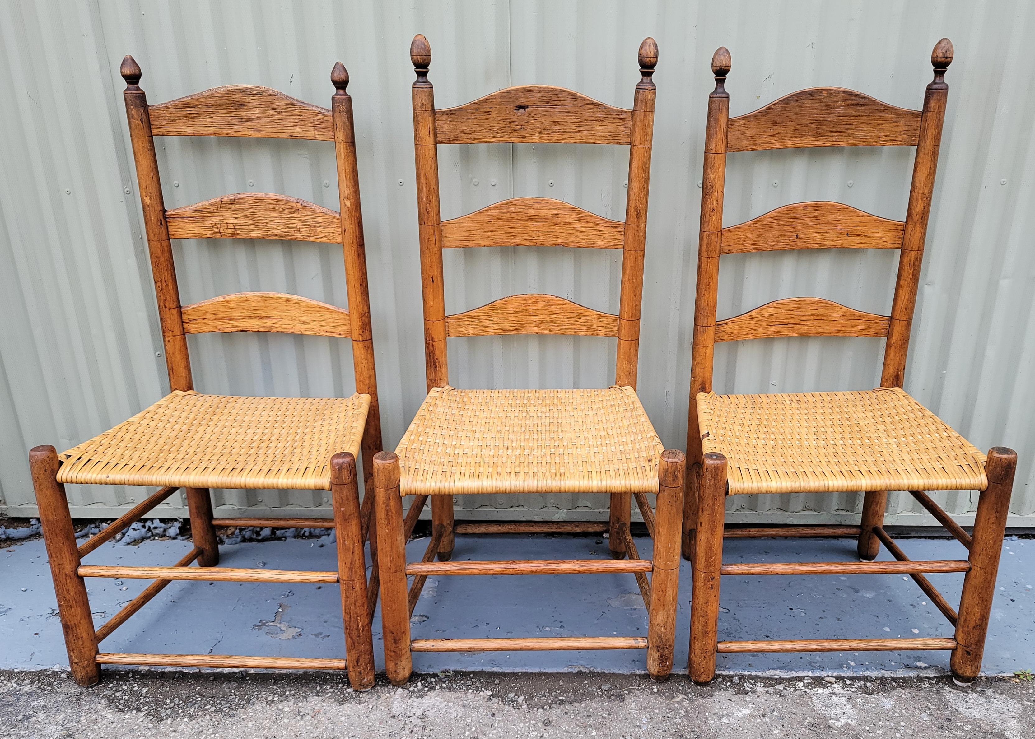 This set of three matching ladder back chairs are in very good condition and fine patina.Great for at a round kitchen table for that fine country look ! They are super comfortable and have newly hand woven seats.