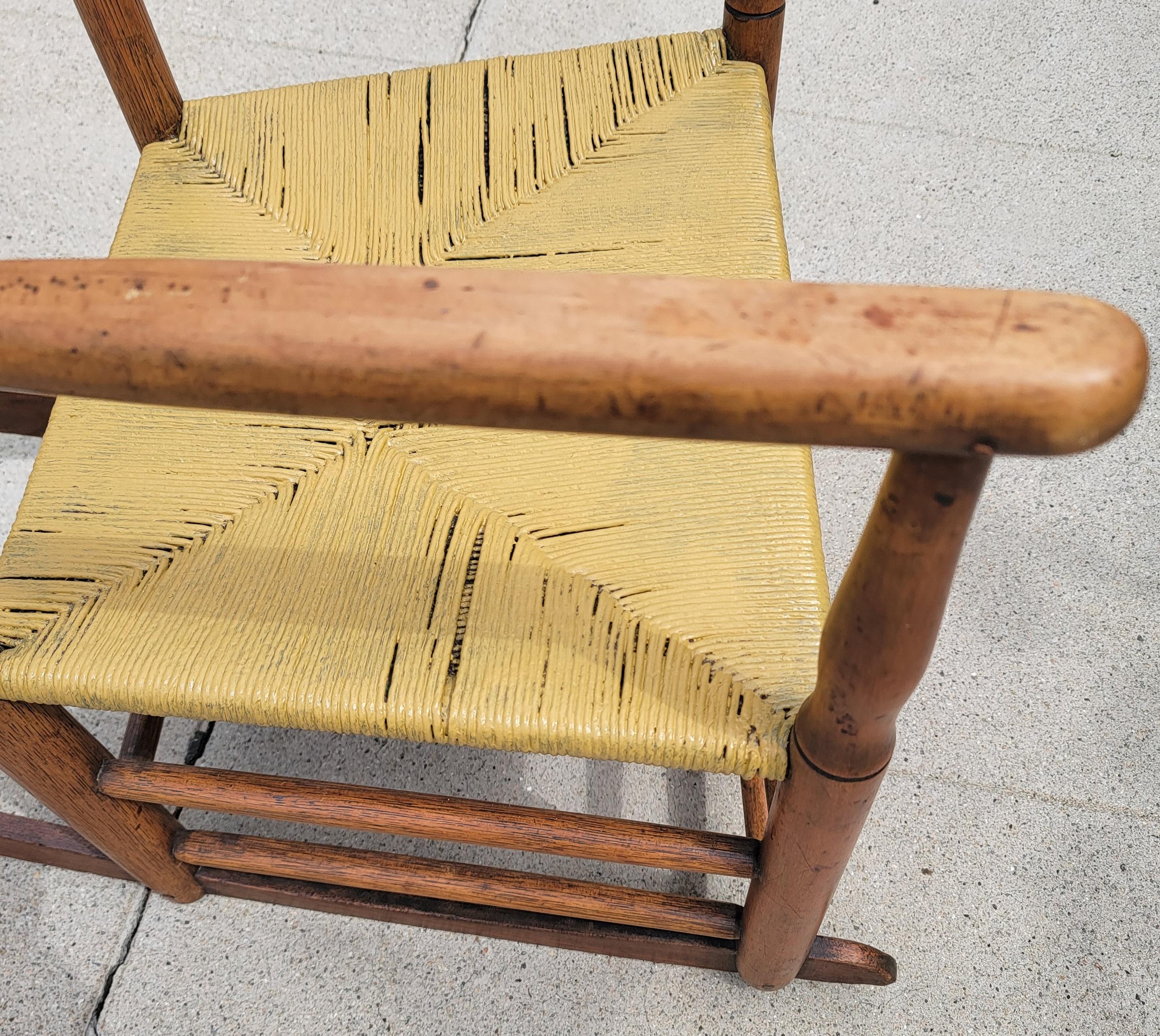 This natural pine ladder back rocking chair is in good sturdy condition with a mustard painted rush seat.The chair has a soft nice patina.