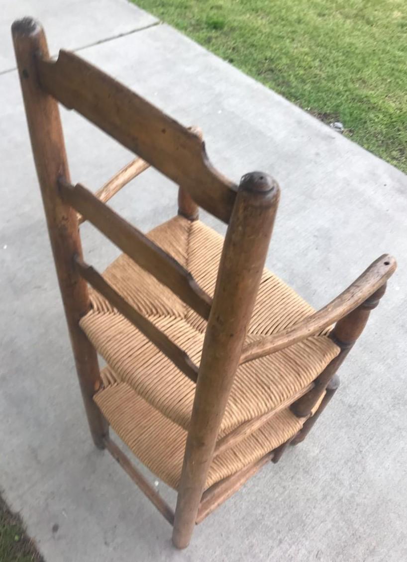19th century ladder back double seat high chair. Believed to be used as a child's barber seat. Early English chair with woven rush seats. This is such a cool folky side chair not sure of its exact purpose.