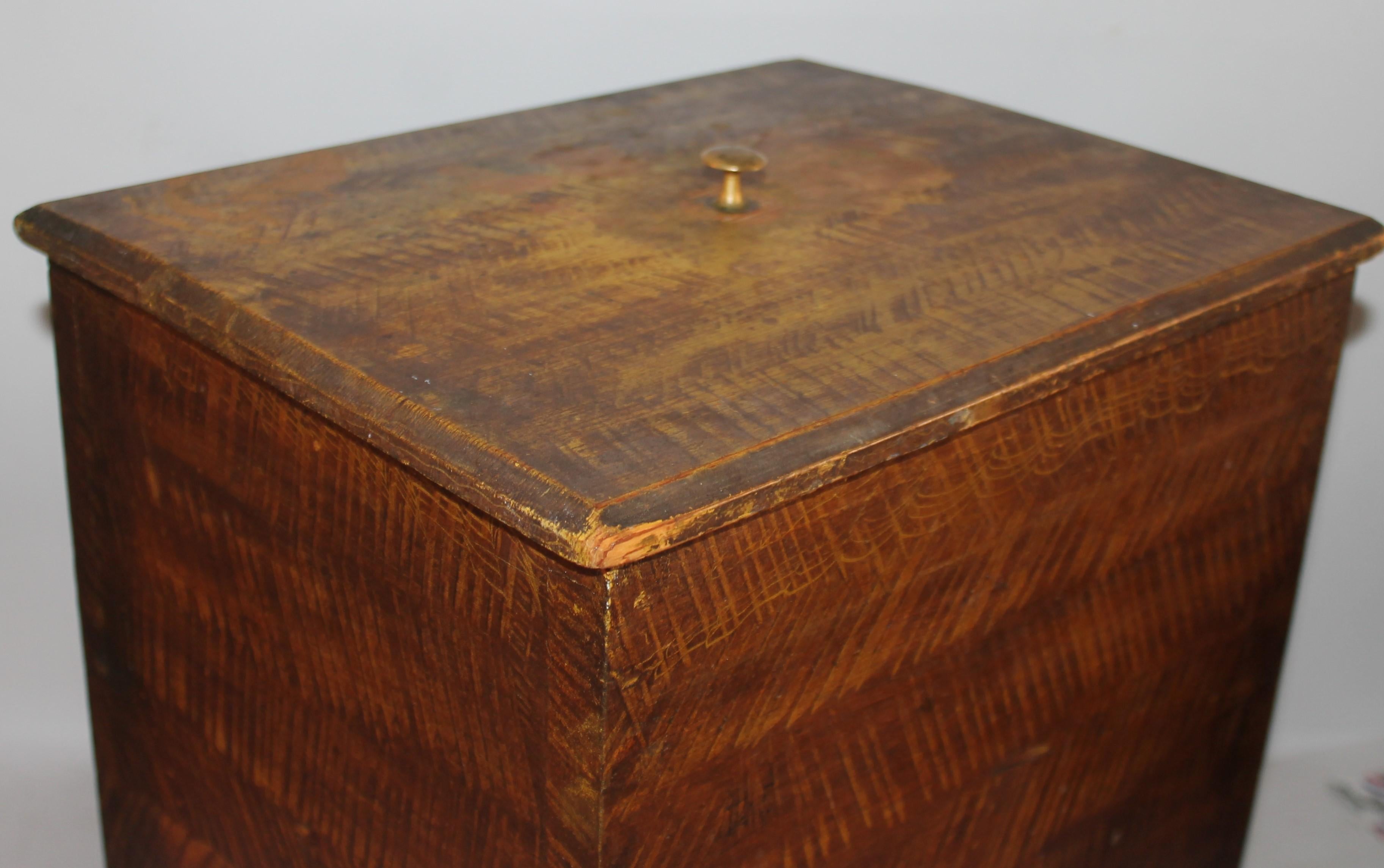 This amazing all original paint decorated or grain painted over mustard painted base is dovetailed construction & square nails as well. The lid comes off and has a brass shaker pull. This also could be a table top flour bin or maybe coal bin. It’s