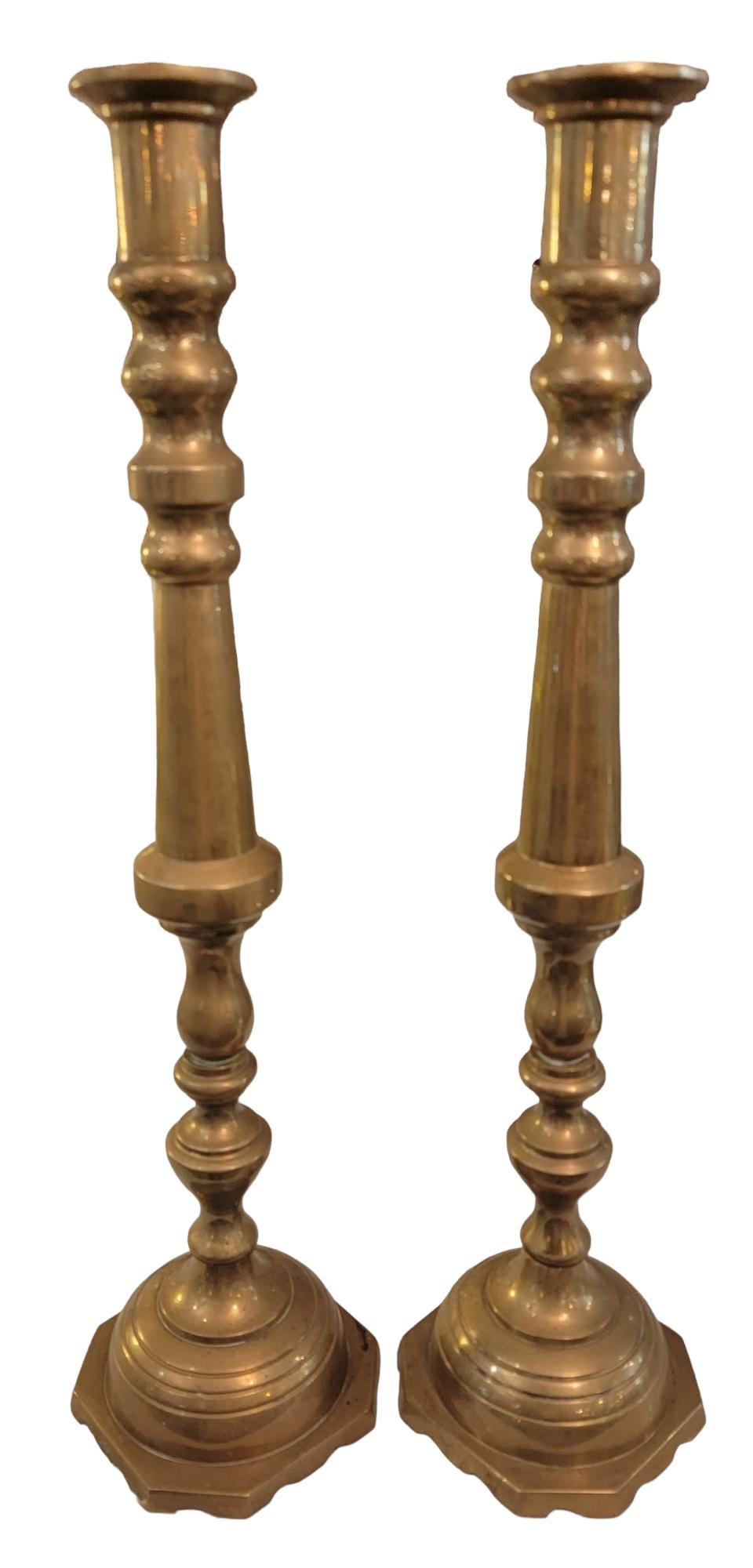 19th century solid brass large English candlesticks. The great weight and the wide base offer incredible stability and strength to the candlesticks.