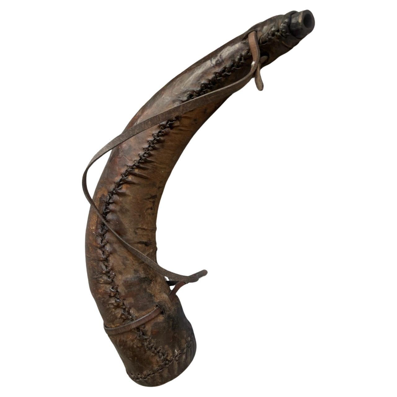 19thc All leather covered Whiskey  horn hand sewn & comes with leather strap.This folky western leather whiskey horn is all in original strong condition and has a leather strap for carrying around. Easy to handle.