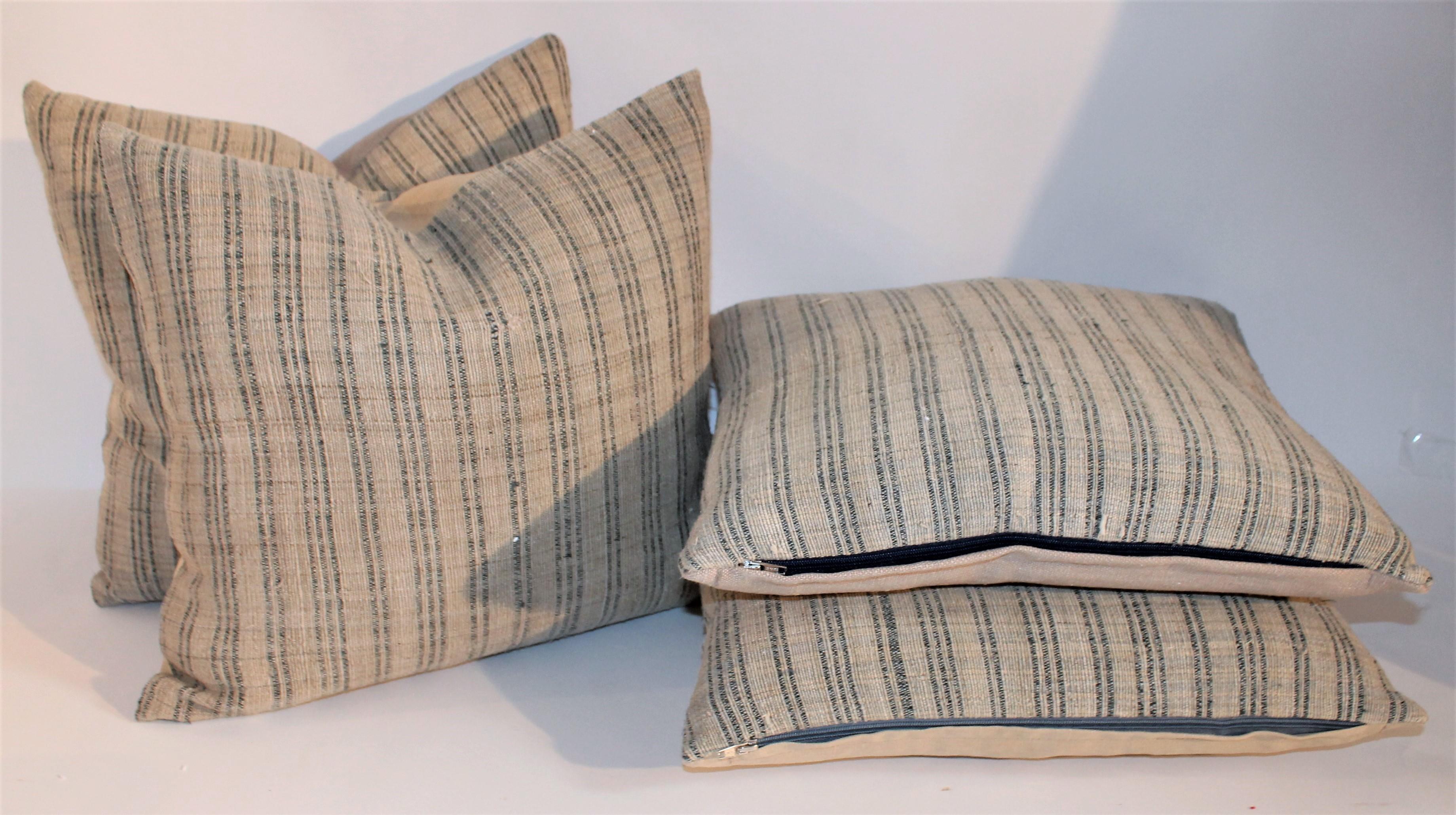 These homespun linen ticking pillows are in pristine condition and have natural linen backing. These natural linen with light blue stripes are very rich and yet country.