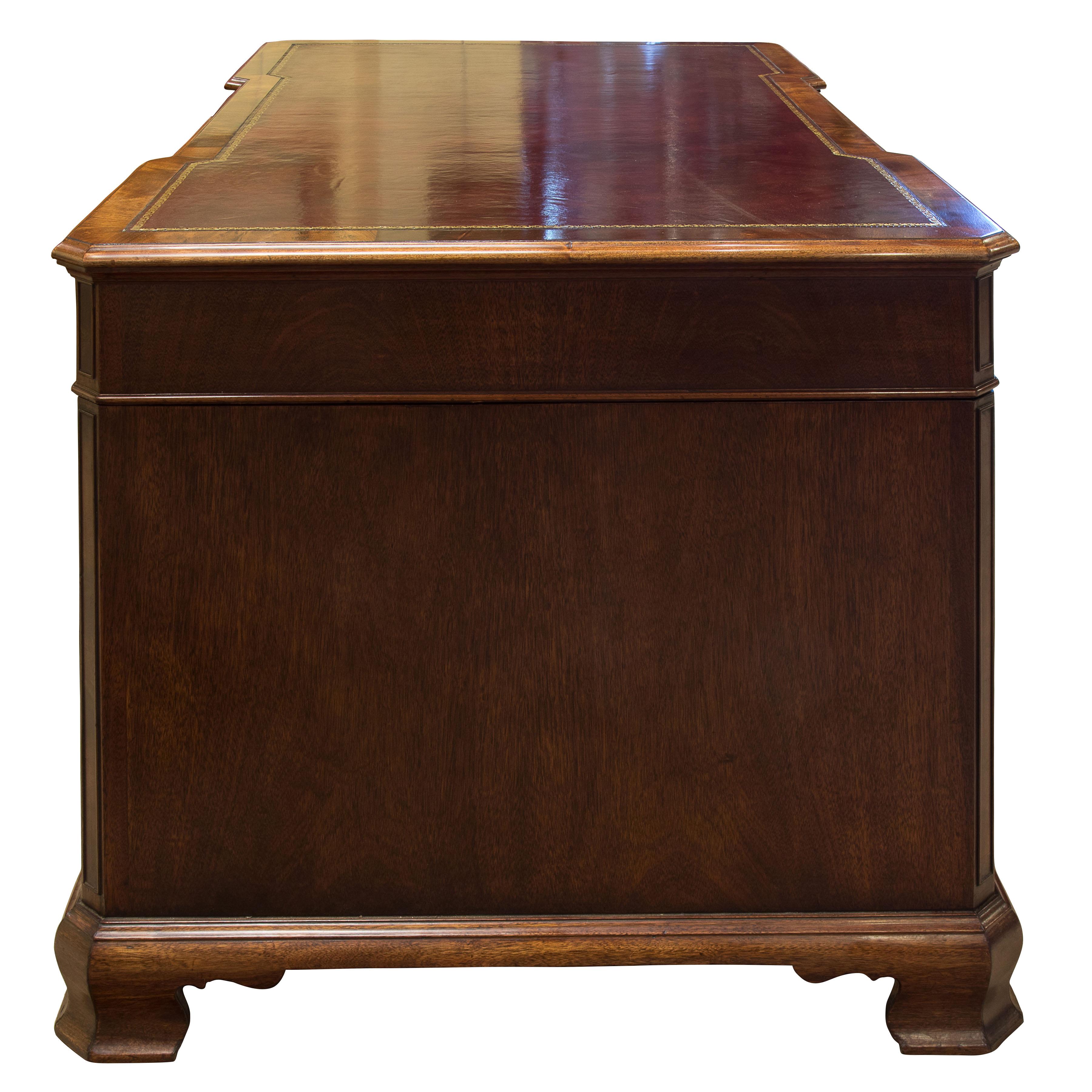 19th century mahogany desk. Inverted breakfront with canted corners shaped bracket feet with skirting reveal. Hand dyed and tooled leather insert,

 

circa 1880.