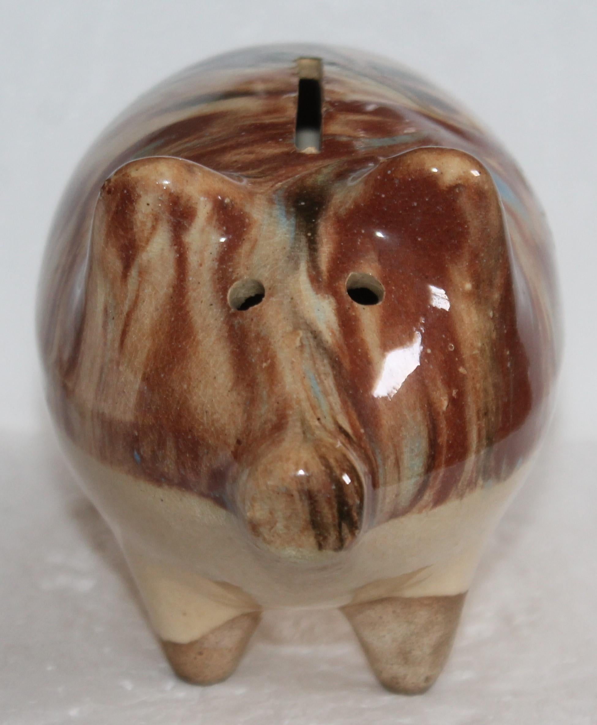 This is a very early stone ware glazed piggy bank from New England. This is a handmade piggy bank in very good condition.