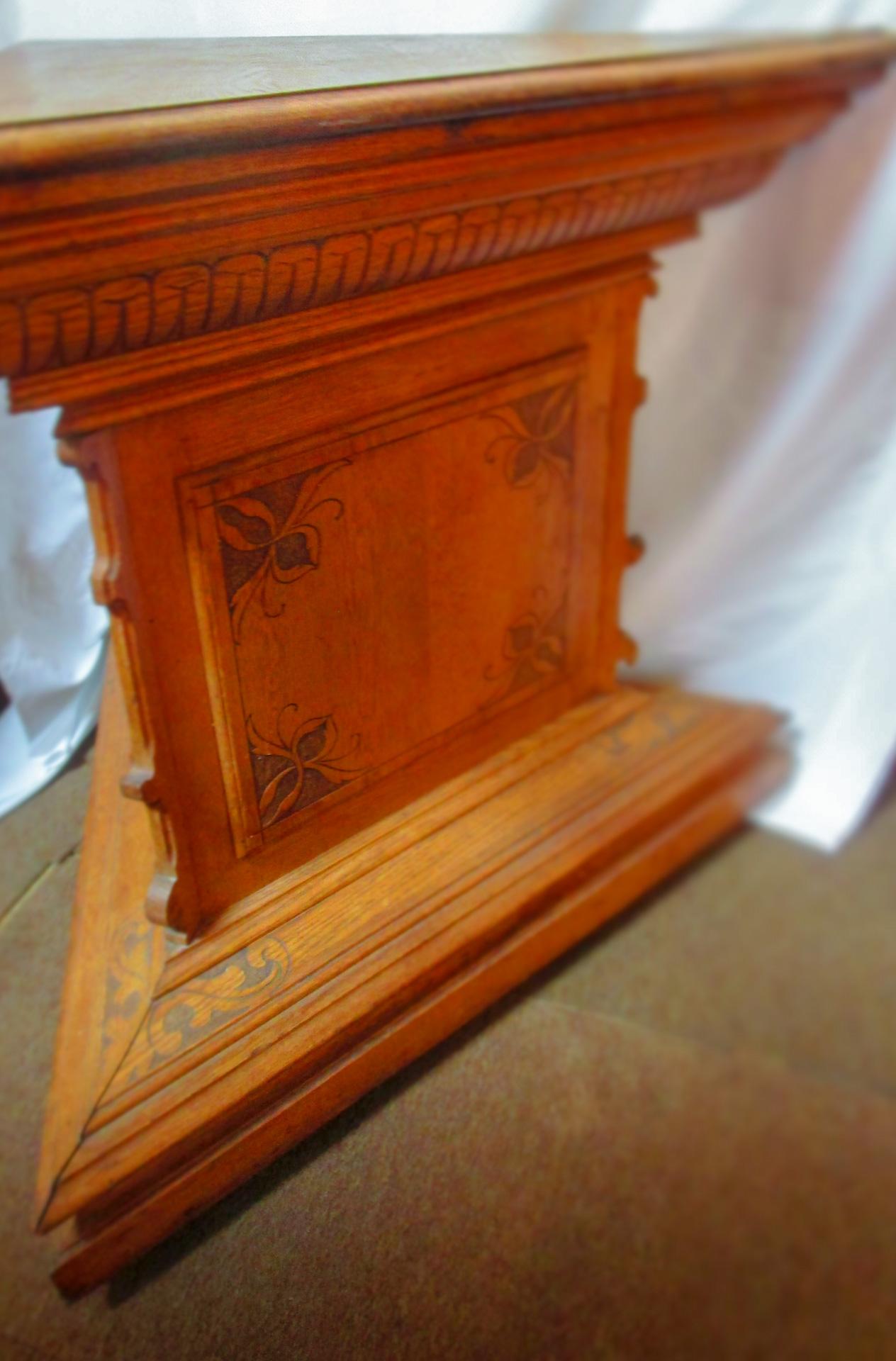 Part of the Masonic emblem is the triangle shape compass which represents the measurement of the ability to undertake actions within certain constraints. This very unusual solid golden oak tri-corner Masonic Lodge table/altar is intricately carved