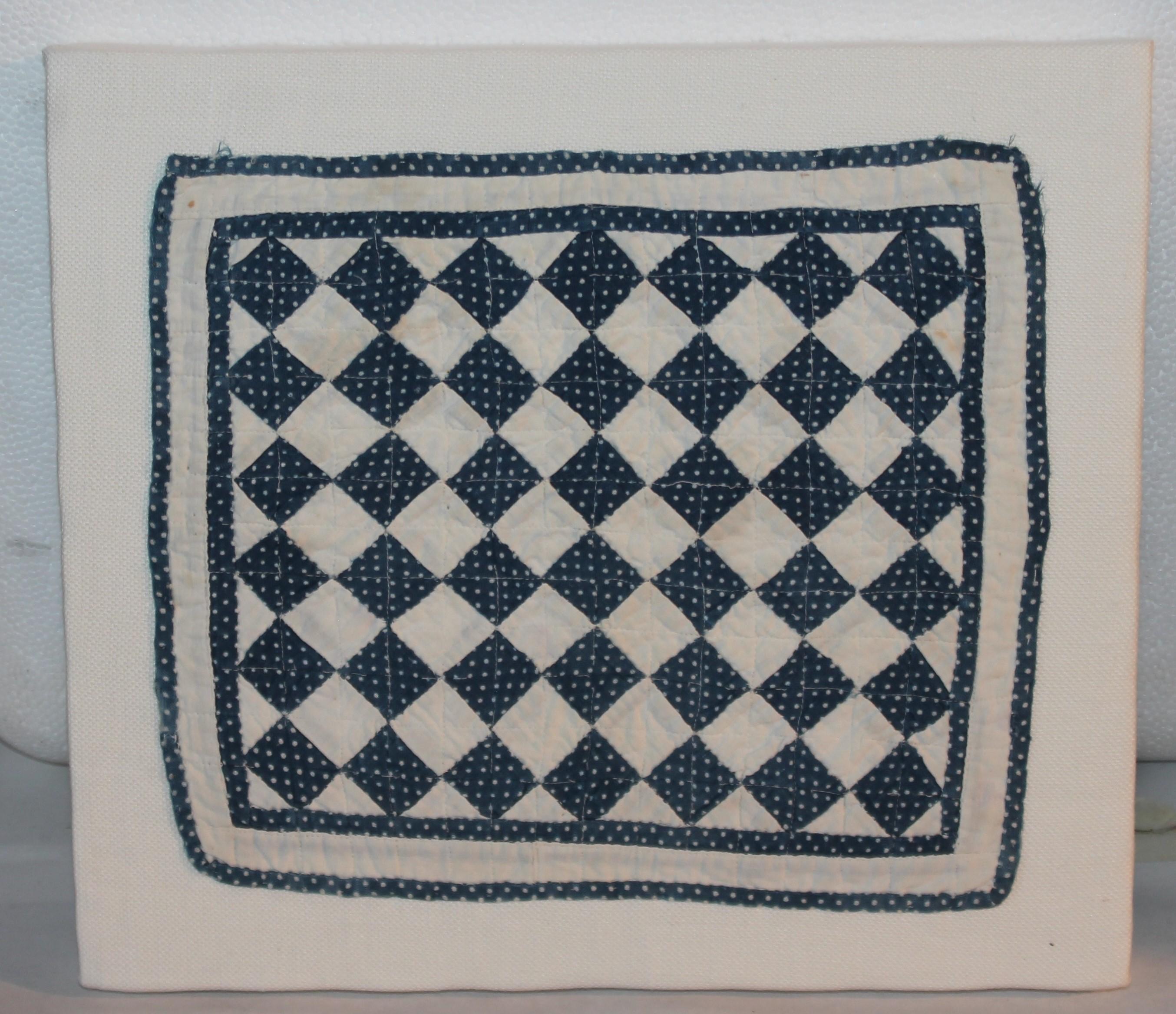 19thc blue & white postage stamp mounted doll quilt sewn on linen. The condition is very good.