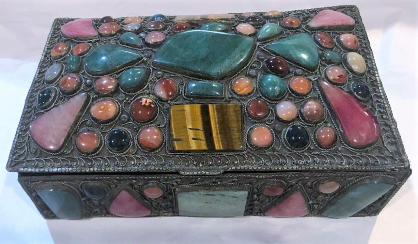 This fine handmade box of silver and brass is very finely detail workmanship. The tumble stones or polished gem stones of a mix of jade, tiger eye and many others. The condition is very good.