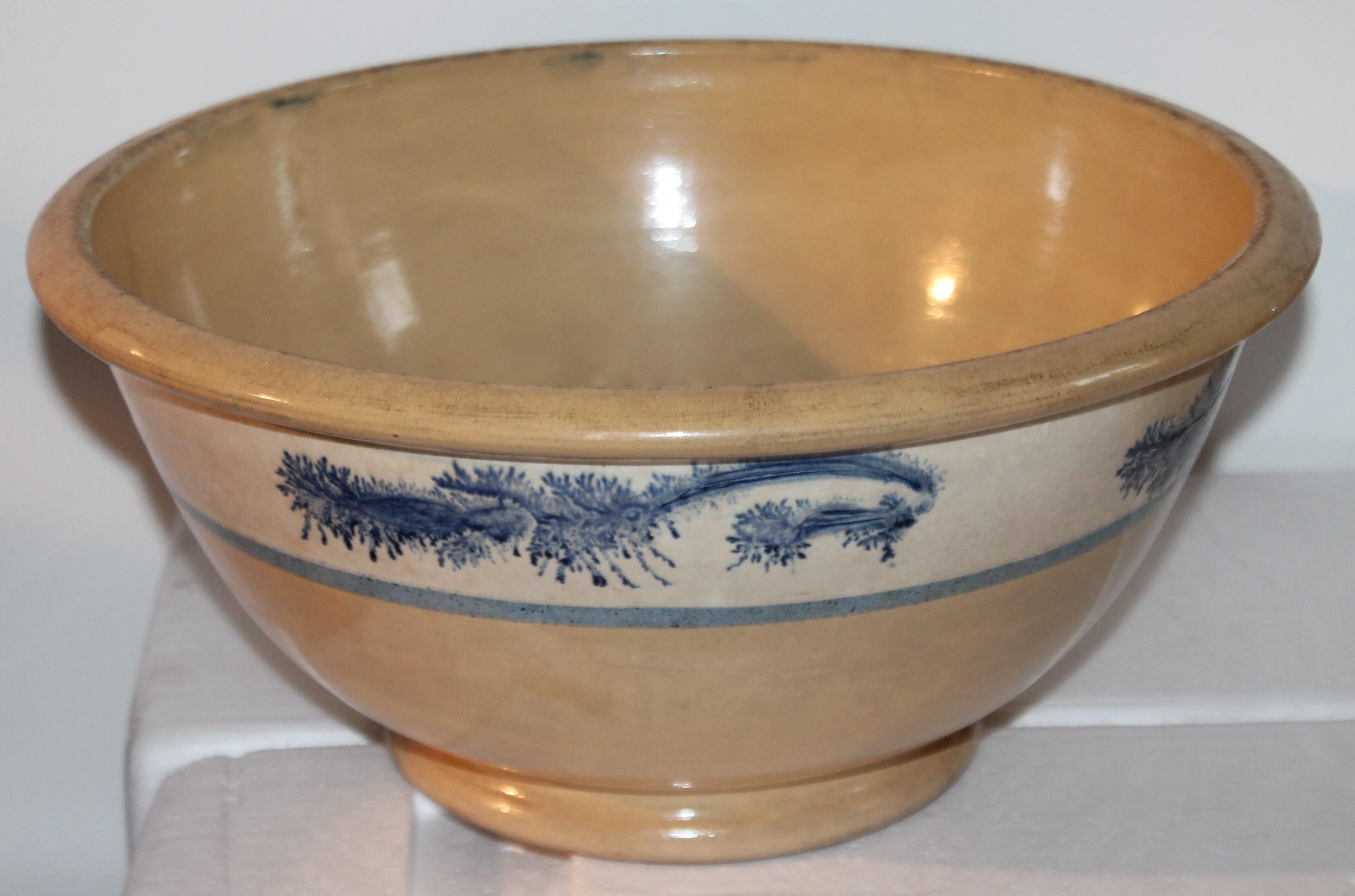 This large mocha blue seaweed yellow ware mixing bowl is in fine condition. Has a very nice decoration of blue seaweed pattern on the outside band.