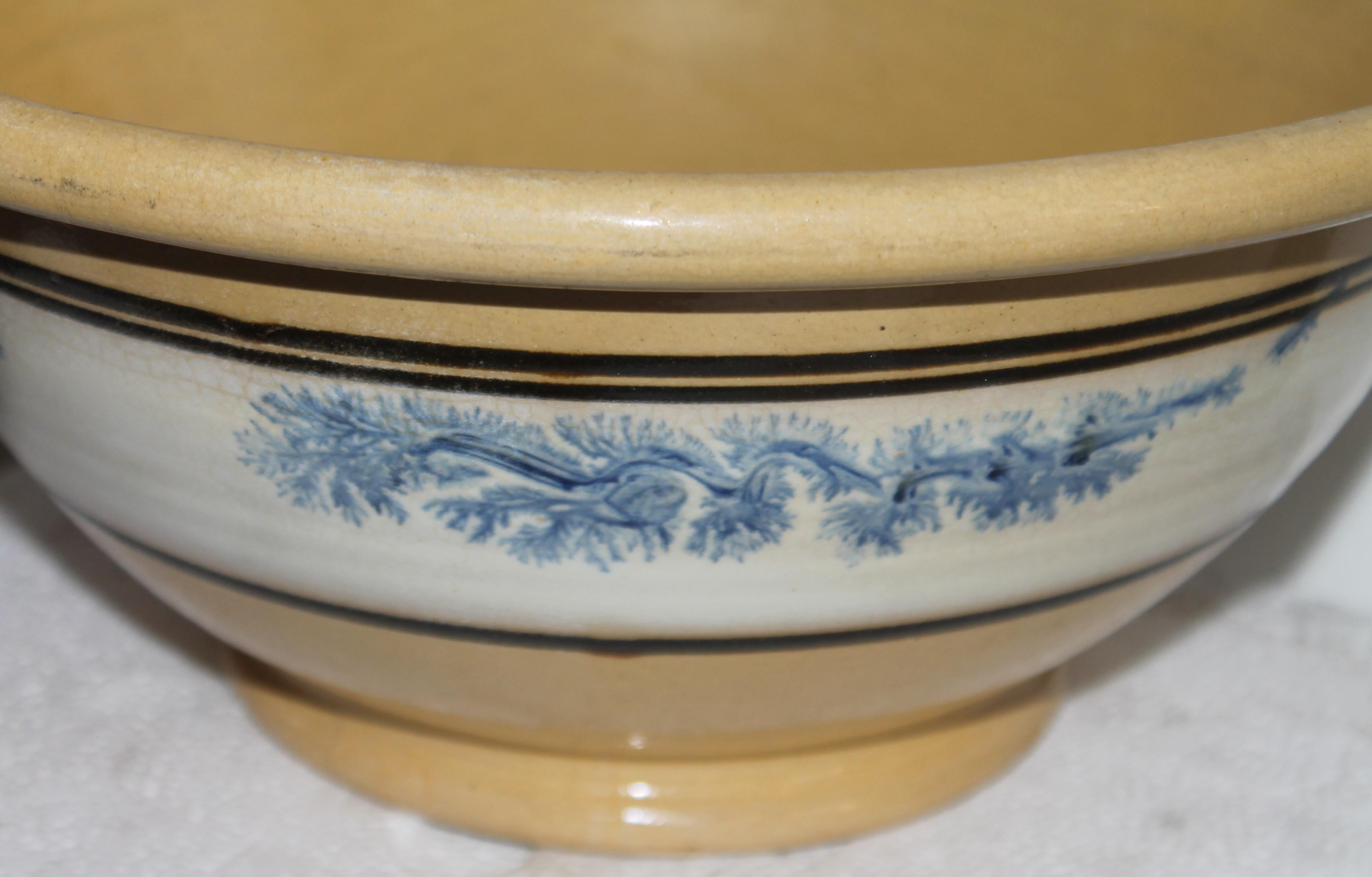This fine very large Mocha Yellow ware bowl with the blue seaweed pattern throughout.