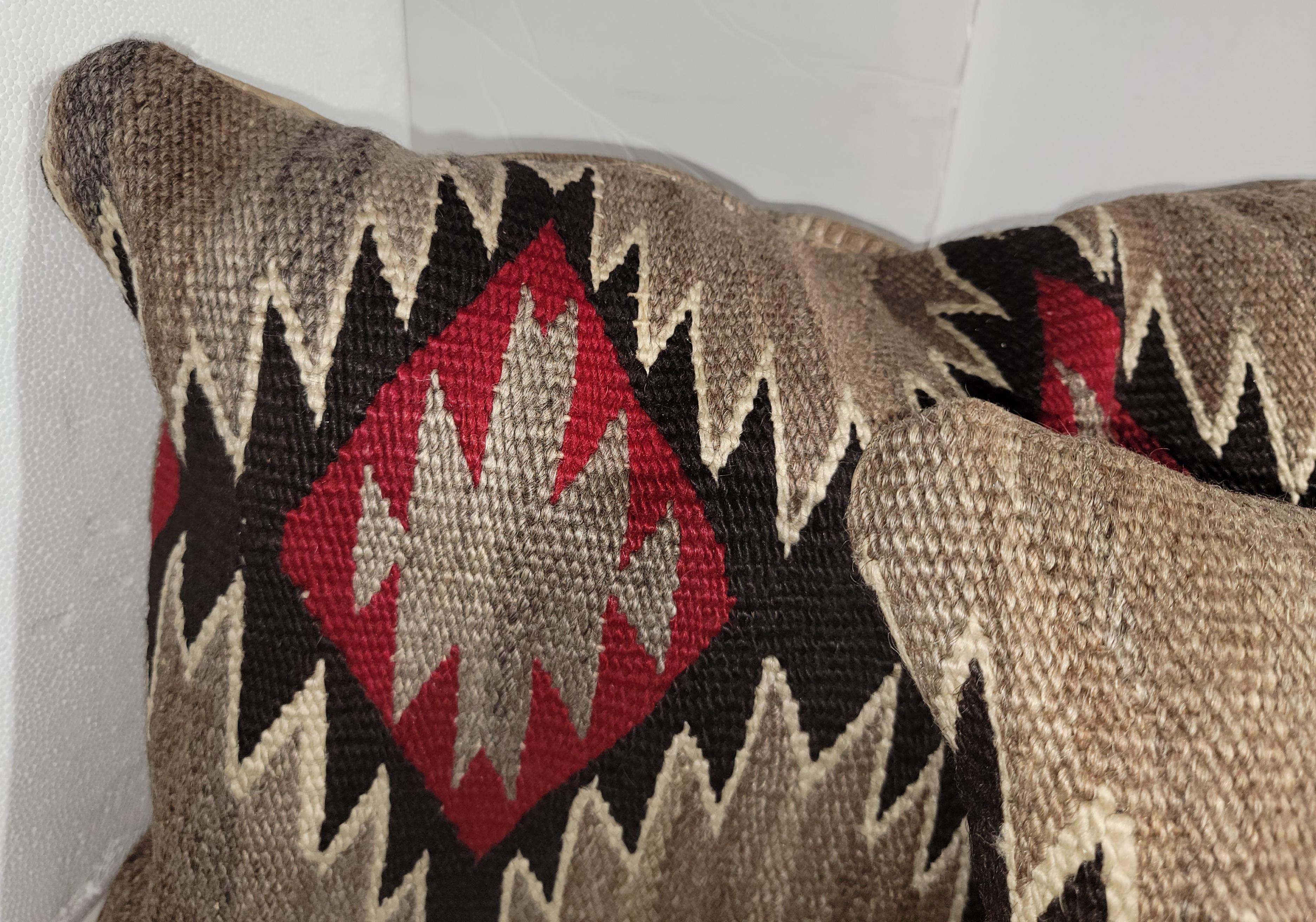 Navajo Indian weaving bolster pillows made from 19thc eye dazzler weaving and backed with distressed leather. The inserts are down & feather fill. Amazing weaving with great vibrant colors and down & feather filled.