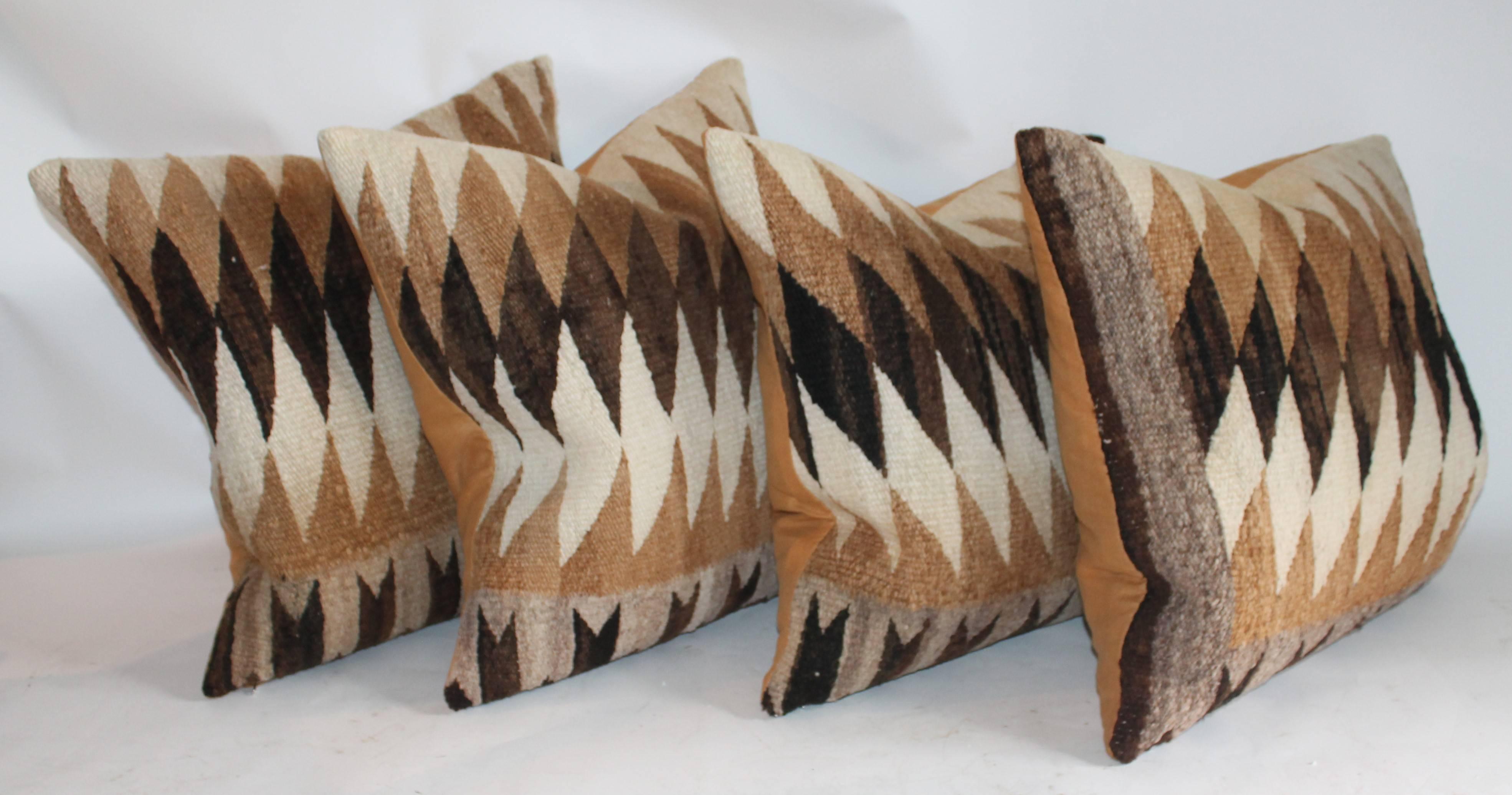 These early Navajo Indian weaving pillows are in fine condition and are sold in pairs. The four look fantastic together. Sold as pairs only. The backing is in a camel cotton linen color.