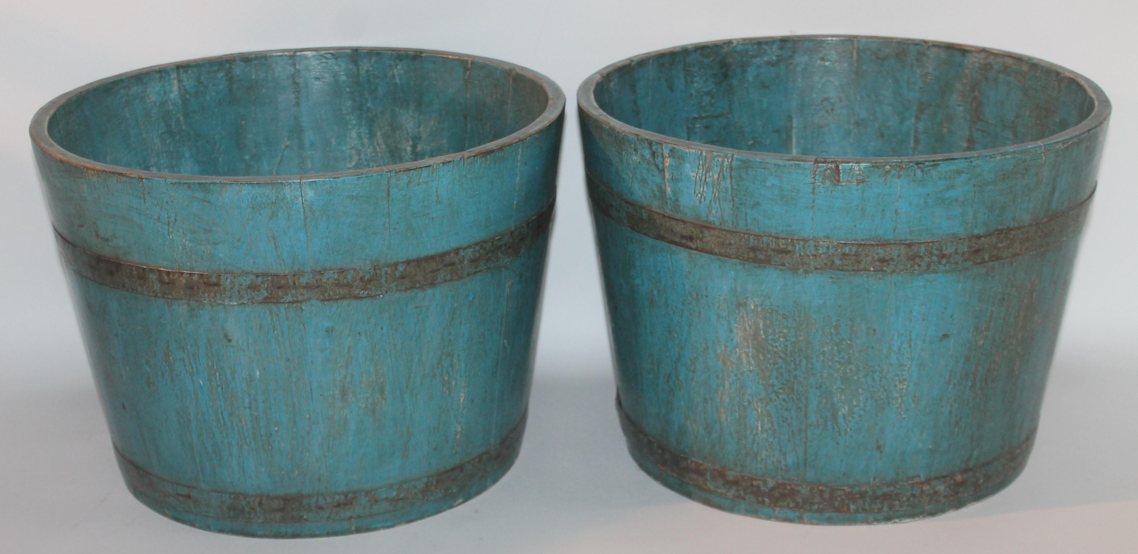These amazing original powder blue buckets or planters are very strong and sturdy. The condition is very good and have a waxed or weather protector finish on them. Fantastic robin egg blue with metal bands holding them together.