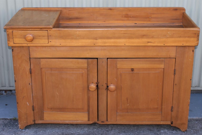 This 19thc pine dry sink cabinet with a drawer is in fine condition. It has a amazing old refinished surface with a nice surface. Fine original backboards.