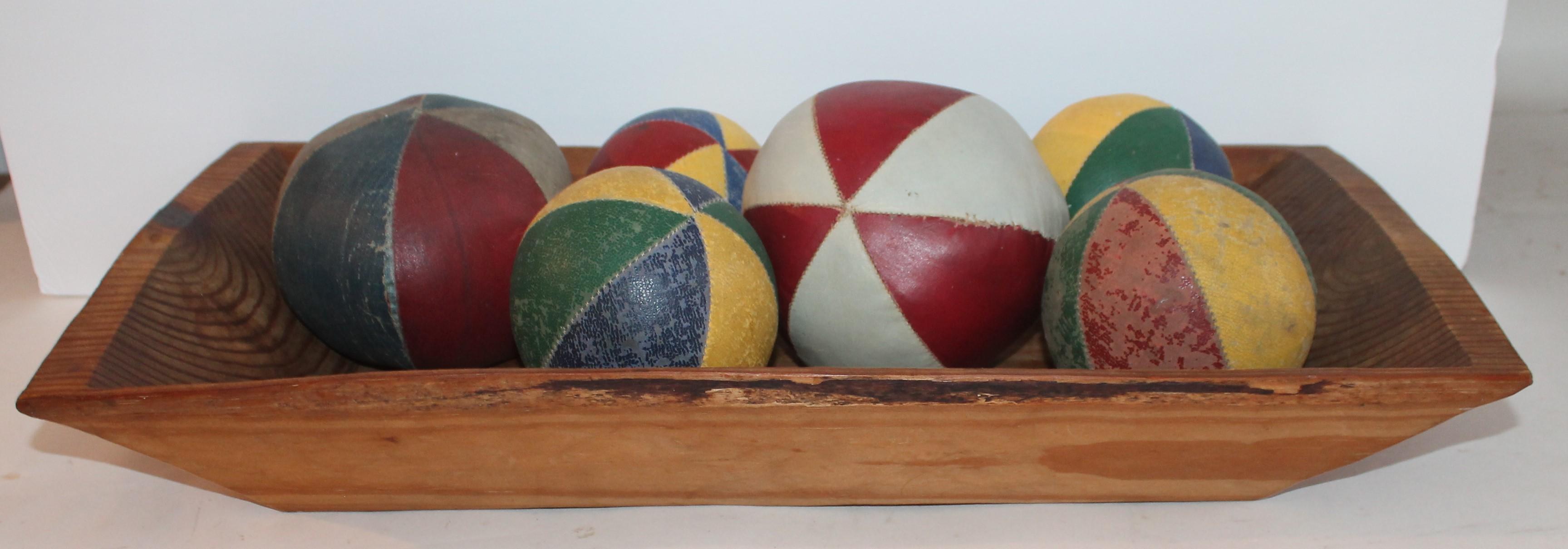 These most unusual oil cloth balls were from a Folk Art collection and are being sold as a collection of six. The smallest ball measures 4 inches in diameter and the largest ball measures 5.5 inches in diameter. 