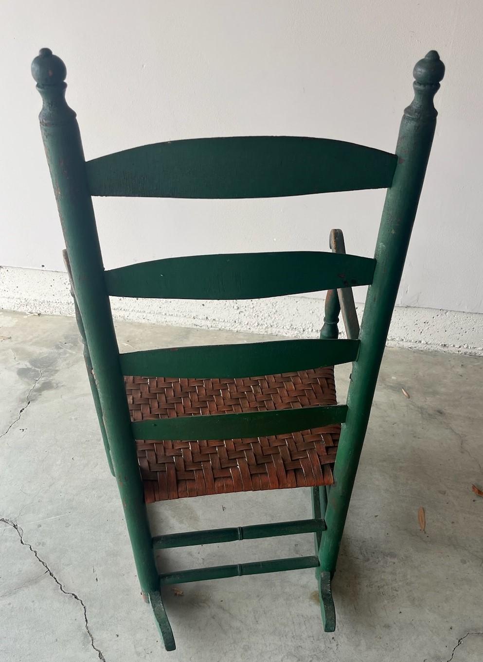 19Thc Original apple green ladder back rocking chair with a hand woven rush seat in a salmon paint. This early New England rocking chair is in amazing condition and very sturdy.
The painted surface is all original and undisturbed.