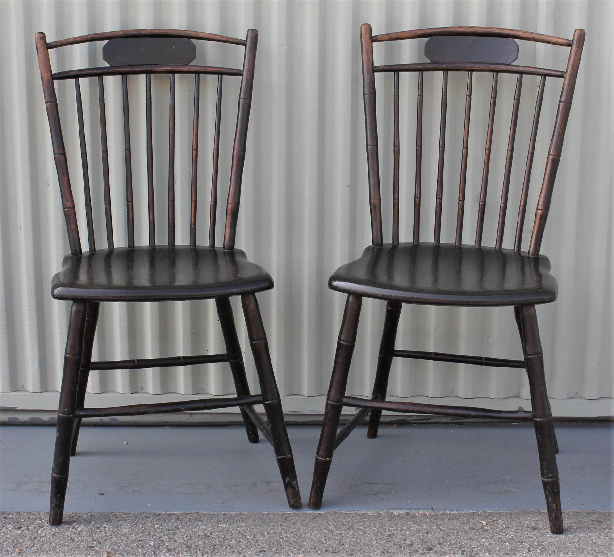 This pair of fine dark painted Windsor chairs retain their original aged patina. The condition is very good and have fantastic pegged construction. The pair are very sturdy and strong.