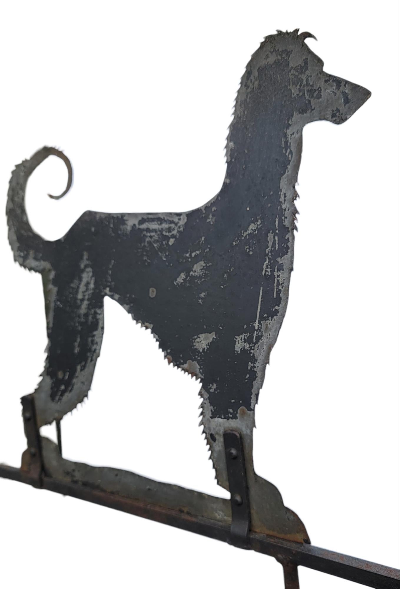 This folky hand made from sheet iron dog weather vane retains its original black painted surface.It was found in New England and is in very good condition.