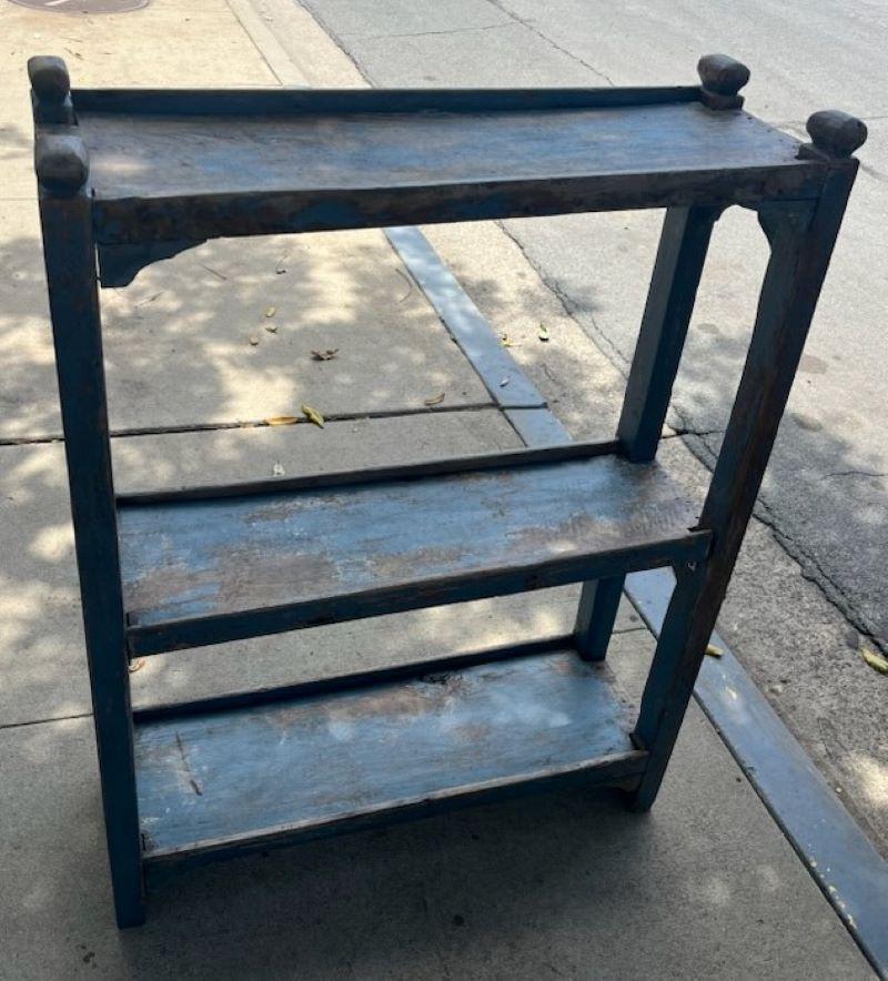 This 19thc bucket bench came from a farmhouse in Pennsylvania. It is all original blue painted worn and aged surface. It could also be used as a bookshelf or shelf unit in your country house. The shelf is very strong and sturdy.