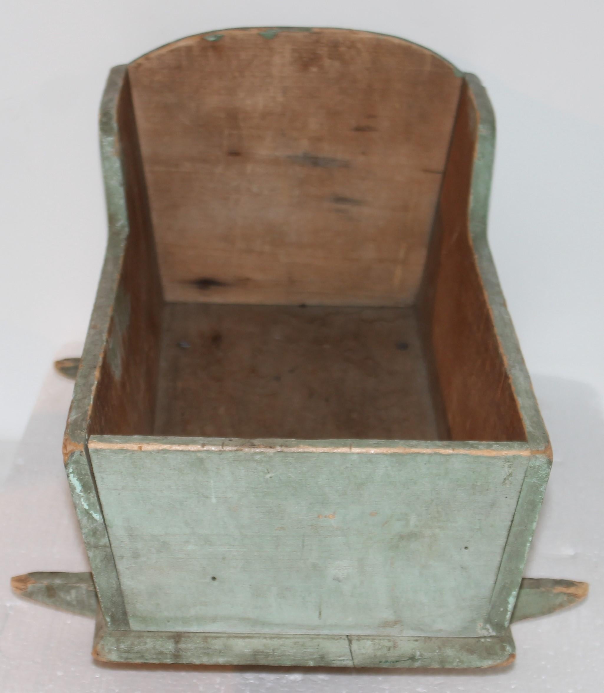 This fine handmade original blue/green doll cradle is in fine condition. It is a dry original first coat of paint and square nail construction. Fantastic form and undisturbed surface.