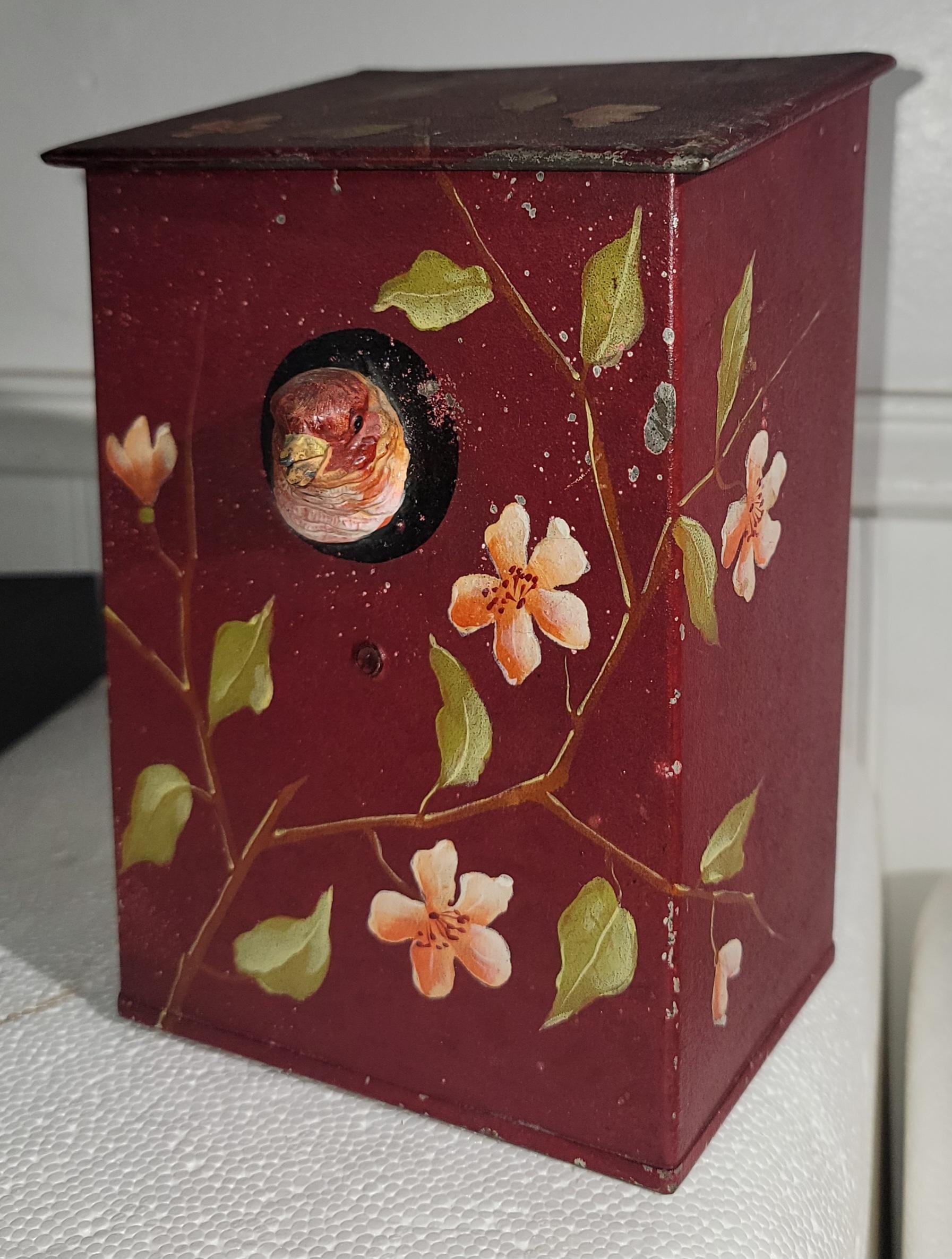 This amazing folk art tole ware box is in original red painted  back round with floral decoration & a embossed bird popping out.