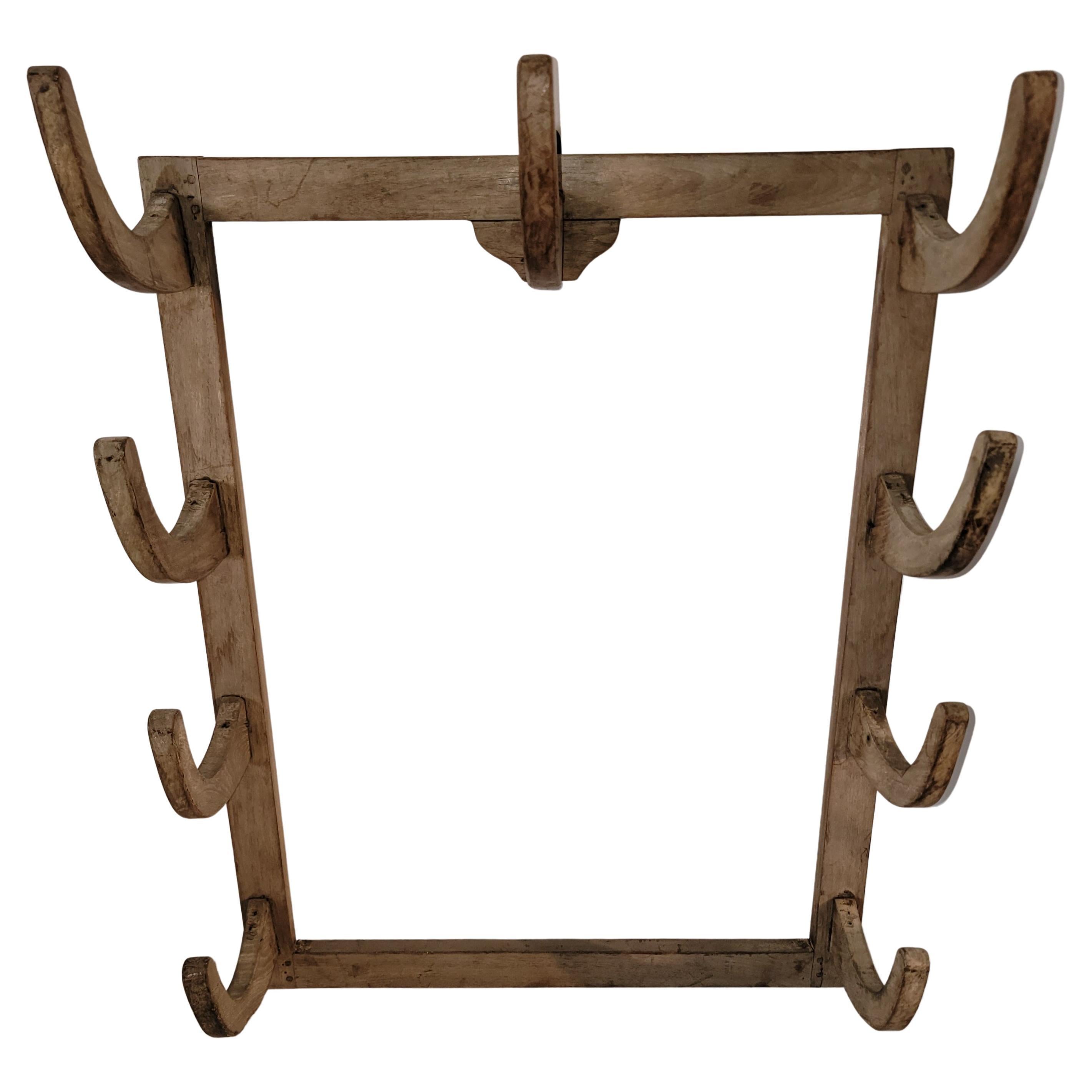 19th C Original wood peg rack from a ranch tack shop in Montana. The condition is very good and super sturdy. We've never owned one so unusual and folky in this form. Great for hanging Navajo weaving's or textiles.