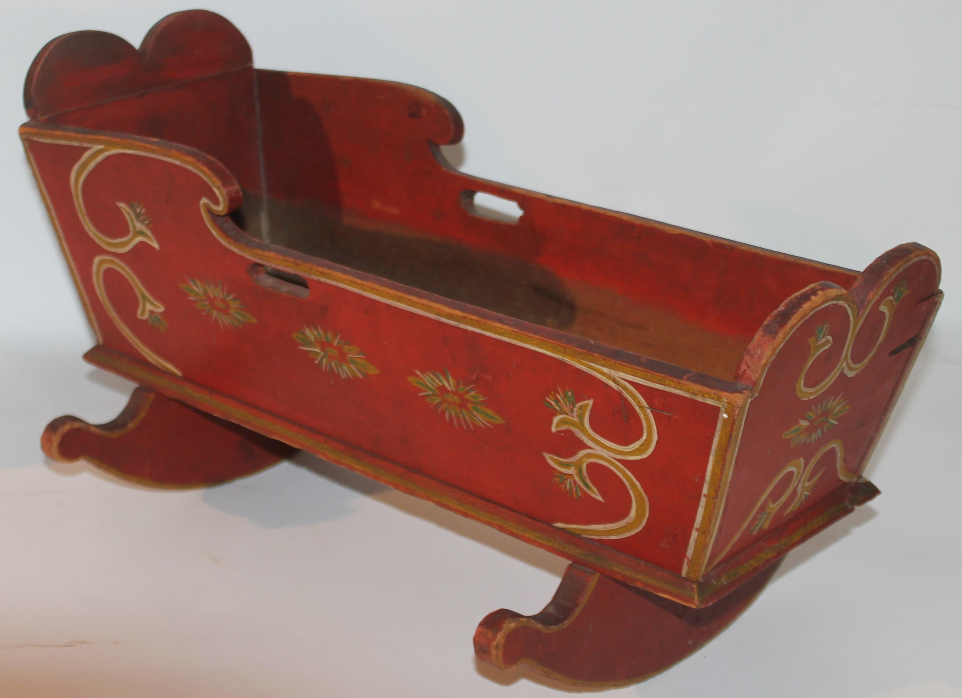 19Thc Original paint decorated doll cradle from Lancaster County, Pennsylvania. This Pennsylvania German Dutch doll cradle is in a bitter sweet painted surface with original decorated trim.