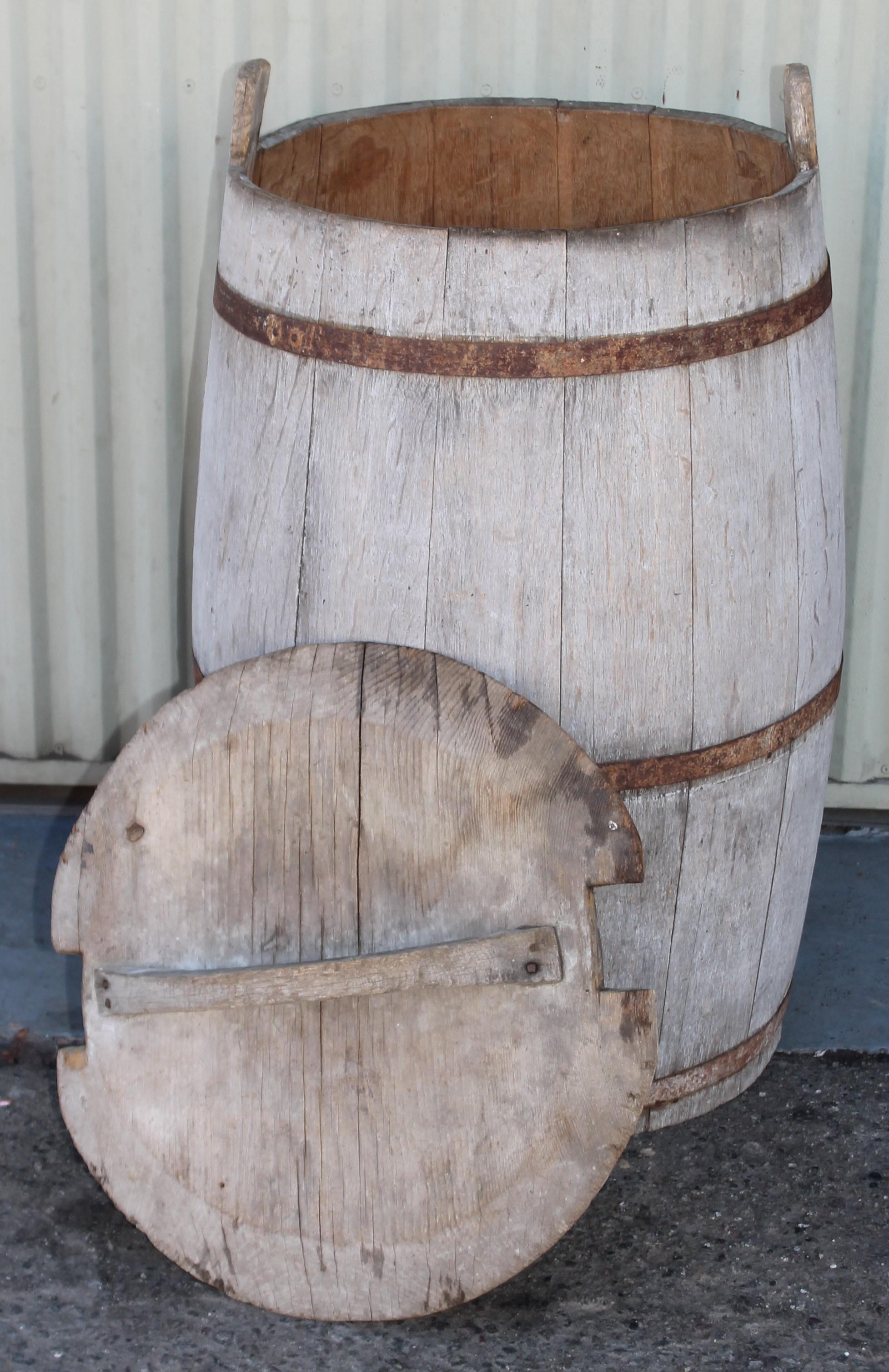 19thc early hand made farmhouse barrel used for storing feed or grains. The barrel has a grey wash of paint and iron straps in tight sturdy condition.