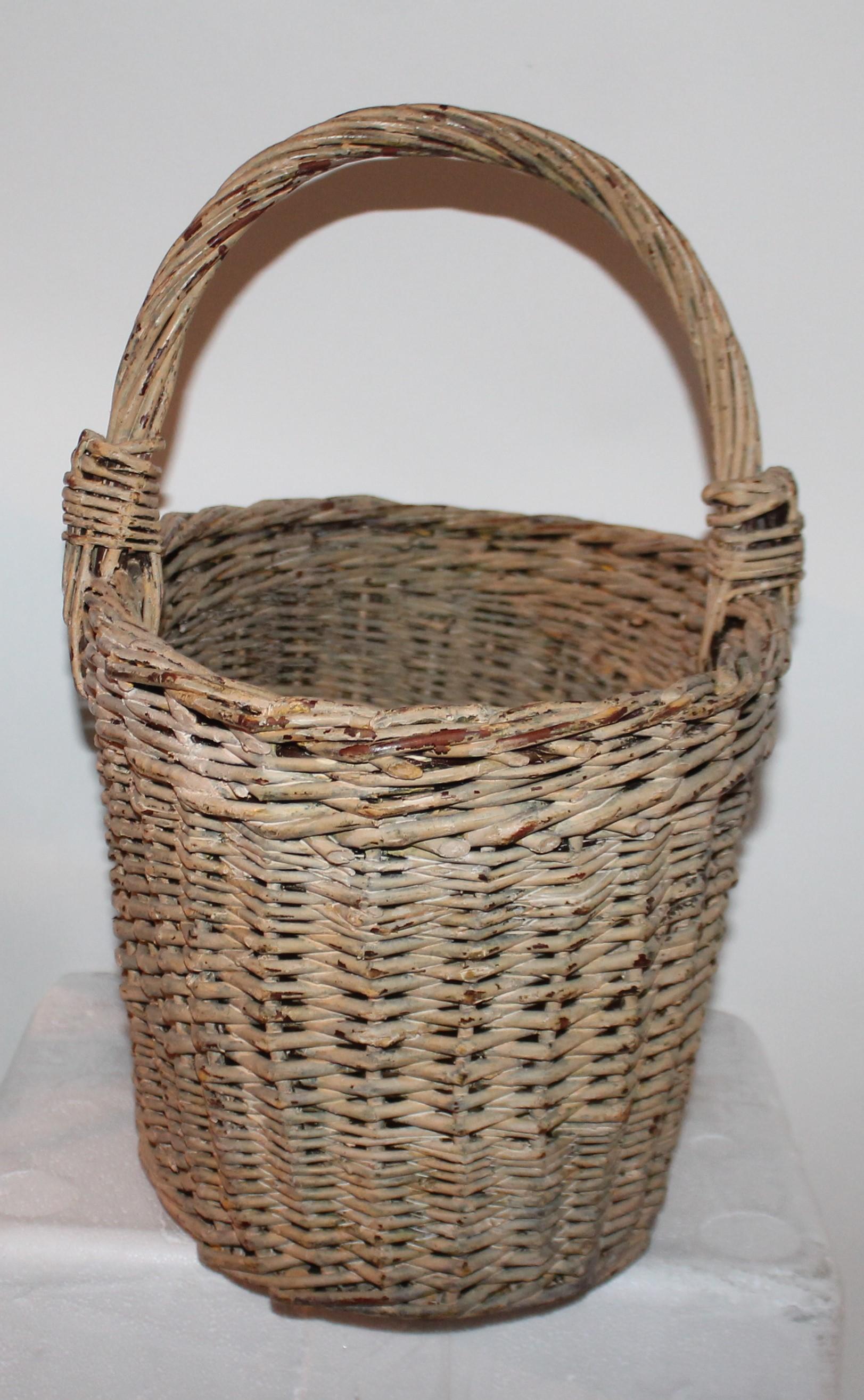 This is a pale yellow handled painted basket is from Pennsylvania. It is in very good condition.