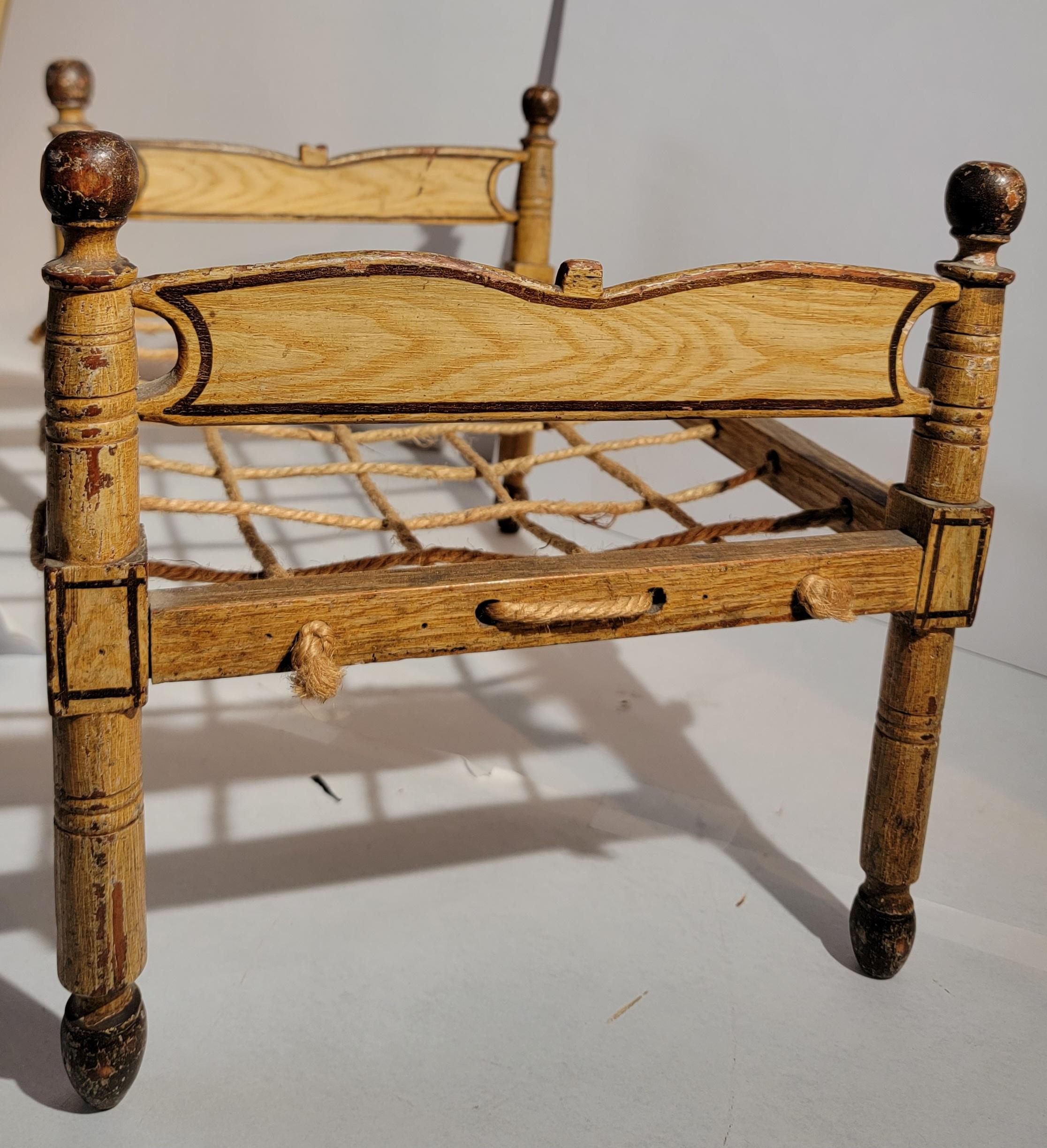 19th century Original paint decorated doll bed from Lancaster County,Pennsylvania in fine as found condition.
